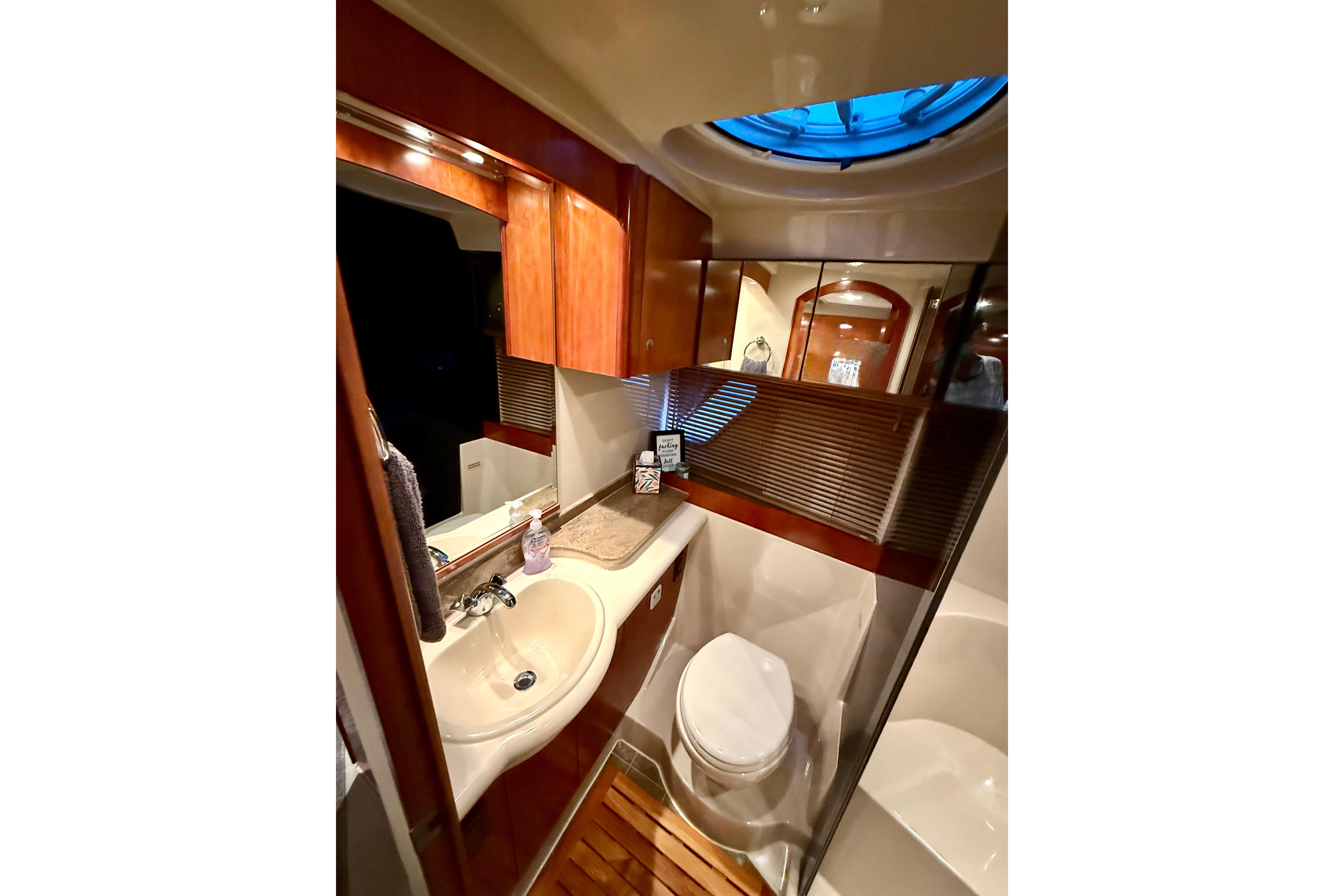 Luxurious bathroom in 2011 Cruisers Yachts 390 Sports Coupe with elegant wood finishes.