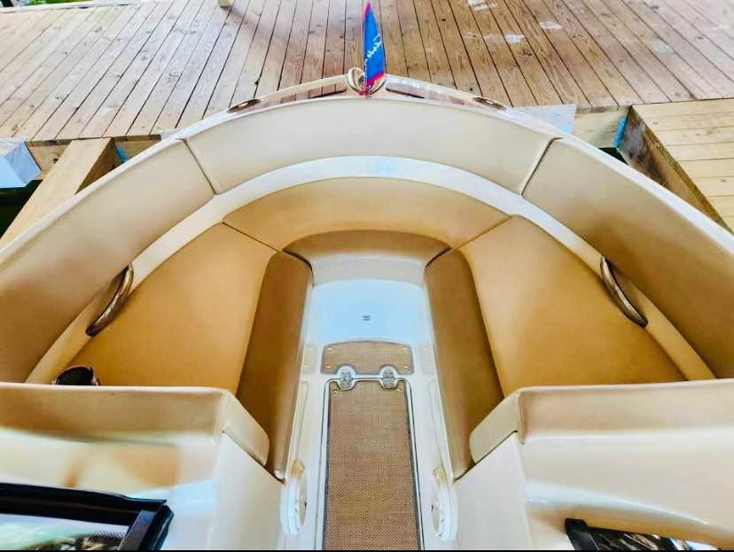 2016 Chris-Craft Carina 21 boat interior with tan seating and wooden deck.