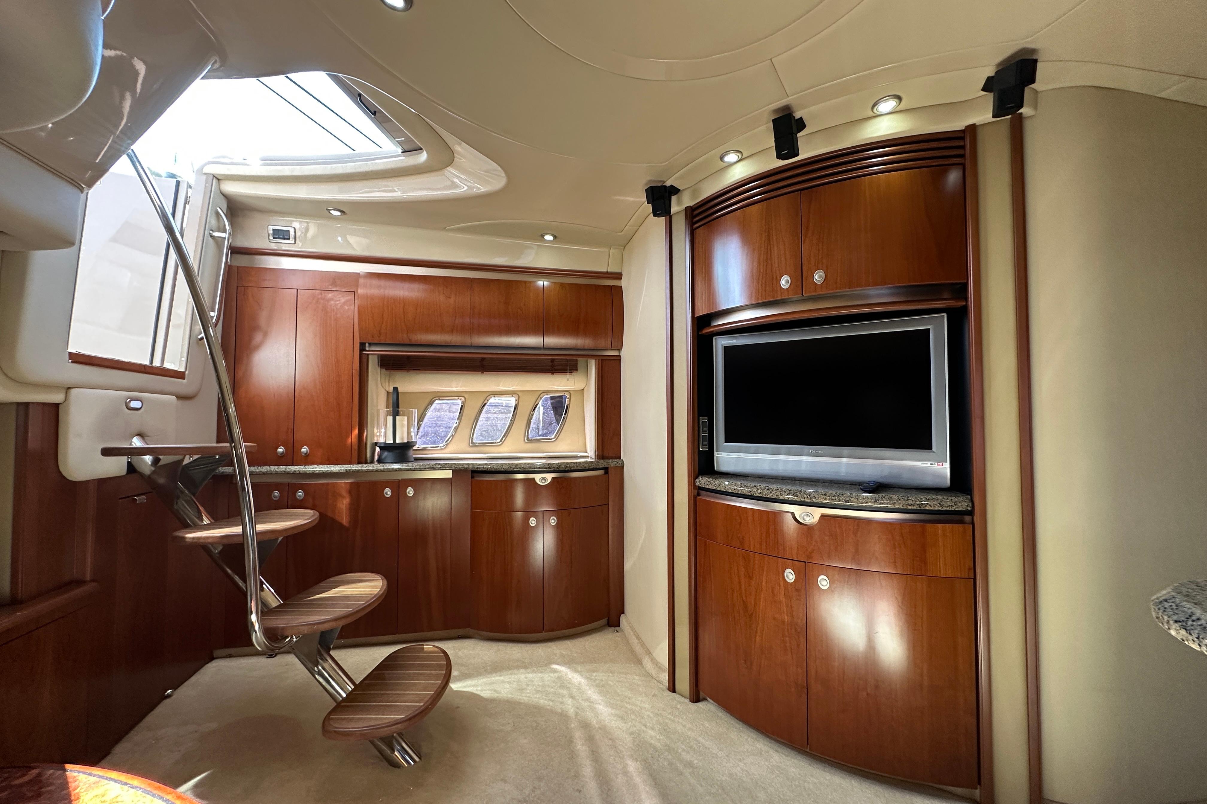 Luxurious interior of 2006 Sea Ray 52 Sundancer yacht with wood cabinetry and modern amenities.