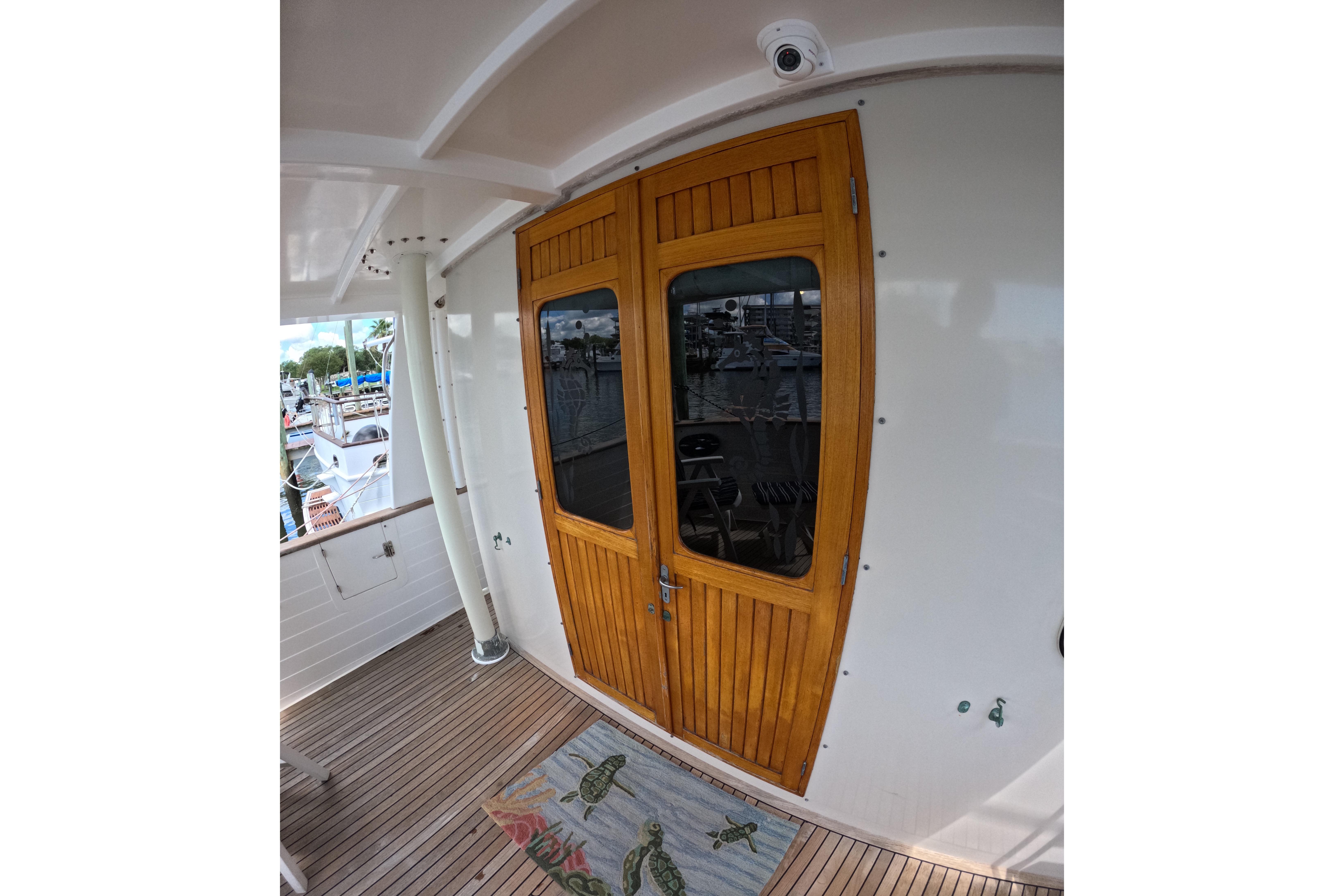 Wooden door on 1999 Kadey-Krogen 48 North Sea yacht, featuring teak deck and nautical decor.