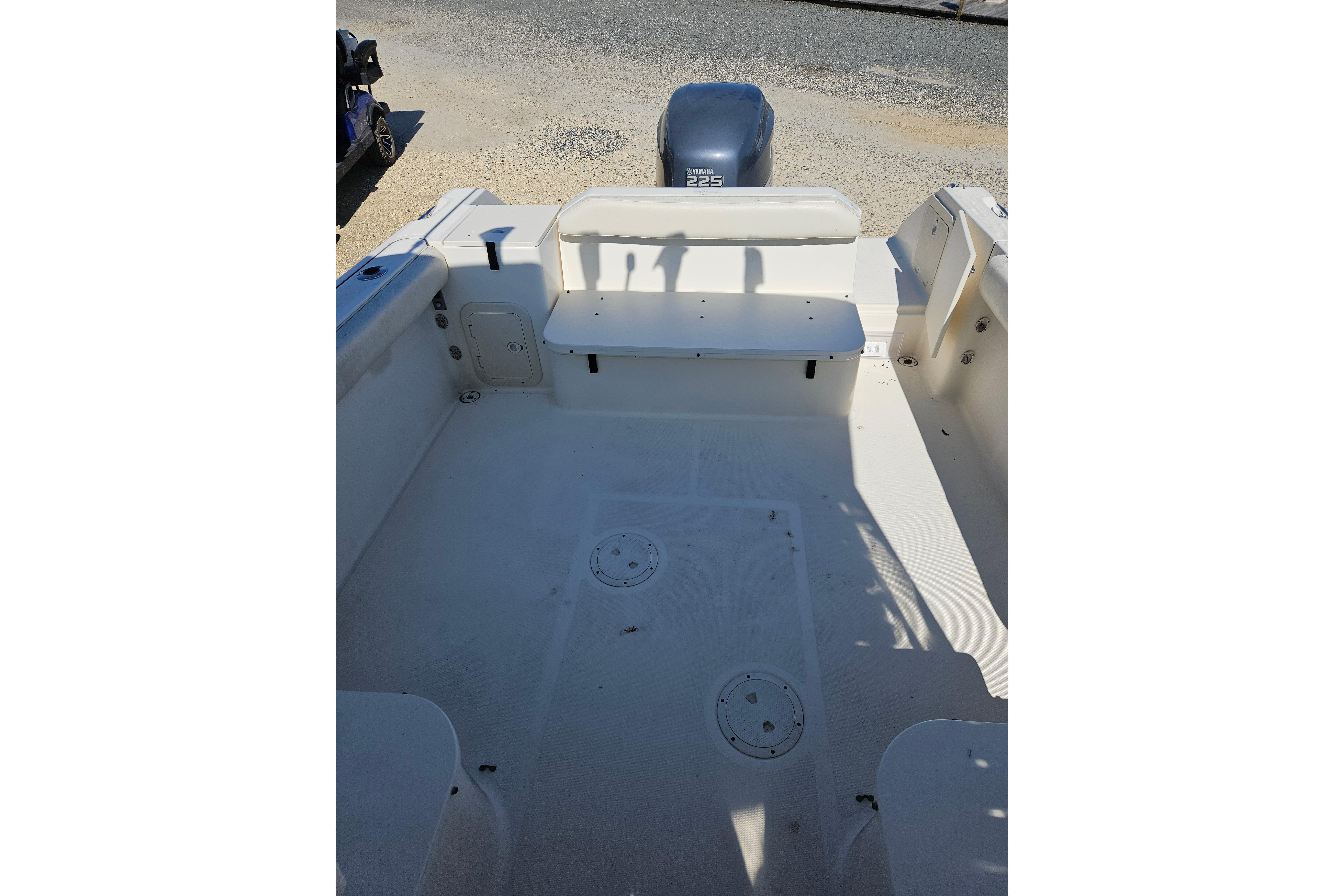 2004 Pursuit 2470 Walkaround boat interior with Yamaha 225 engine.