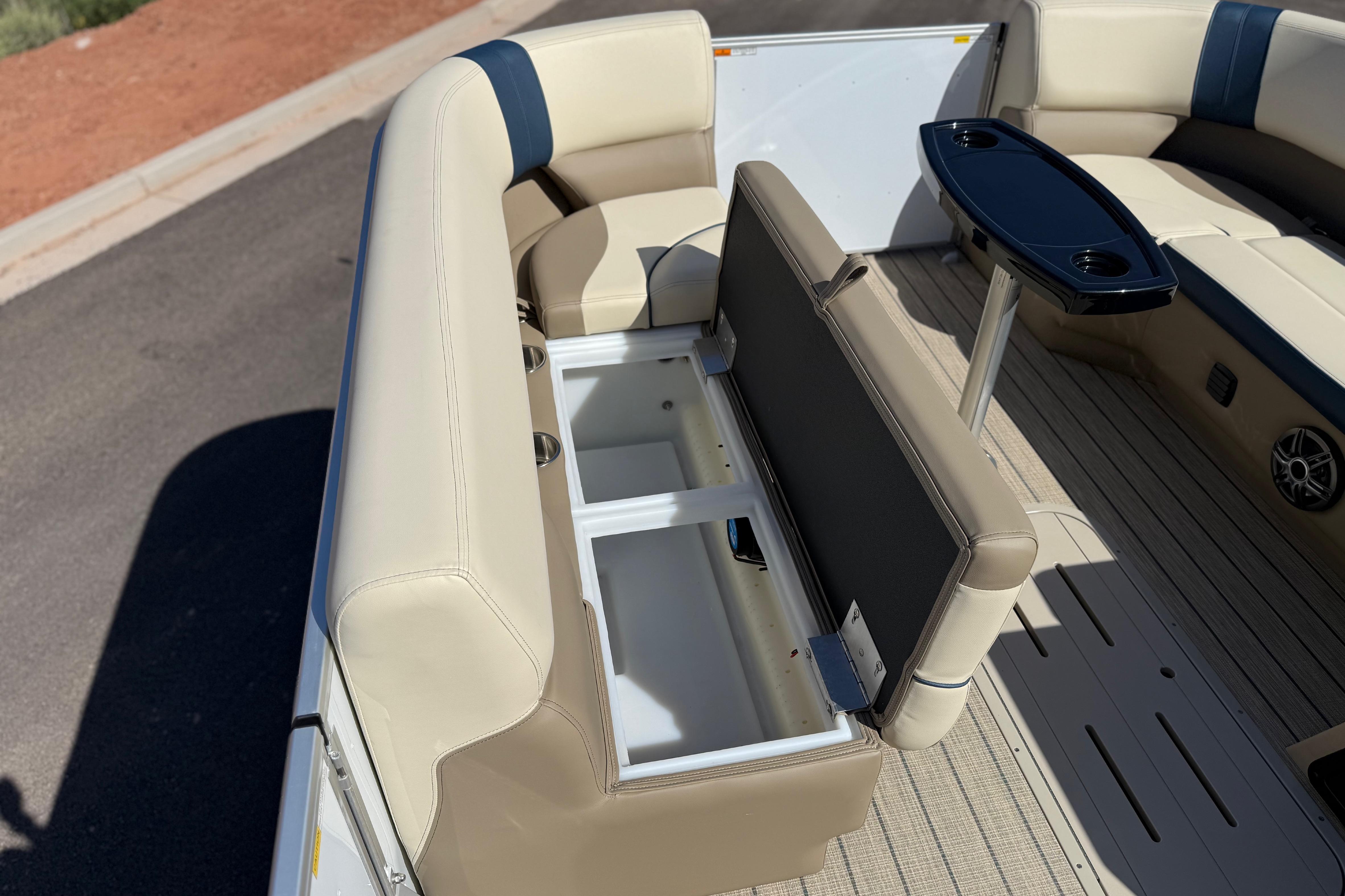 2026 SunCatcher Select 322SL boat interior with open storage compartment and seating.