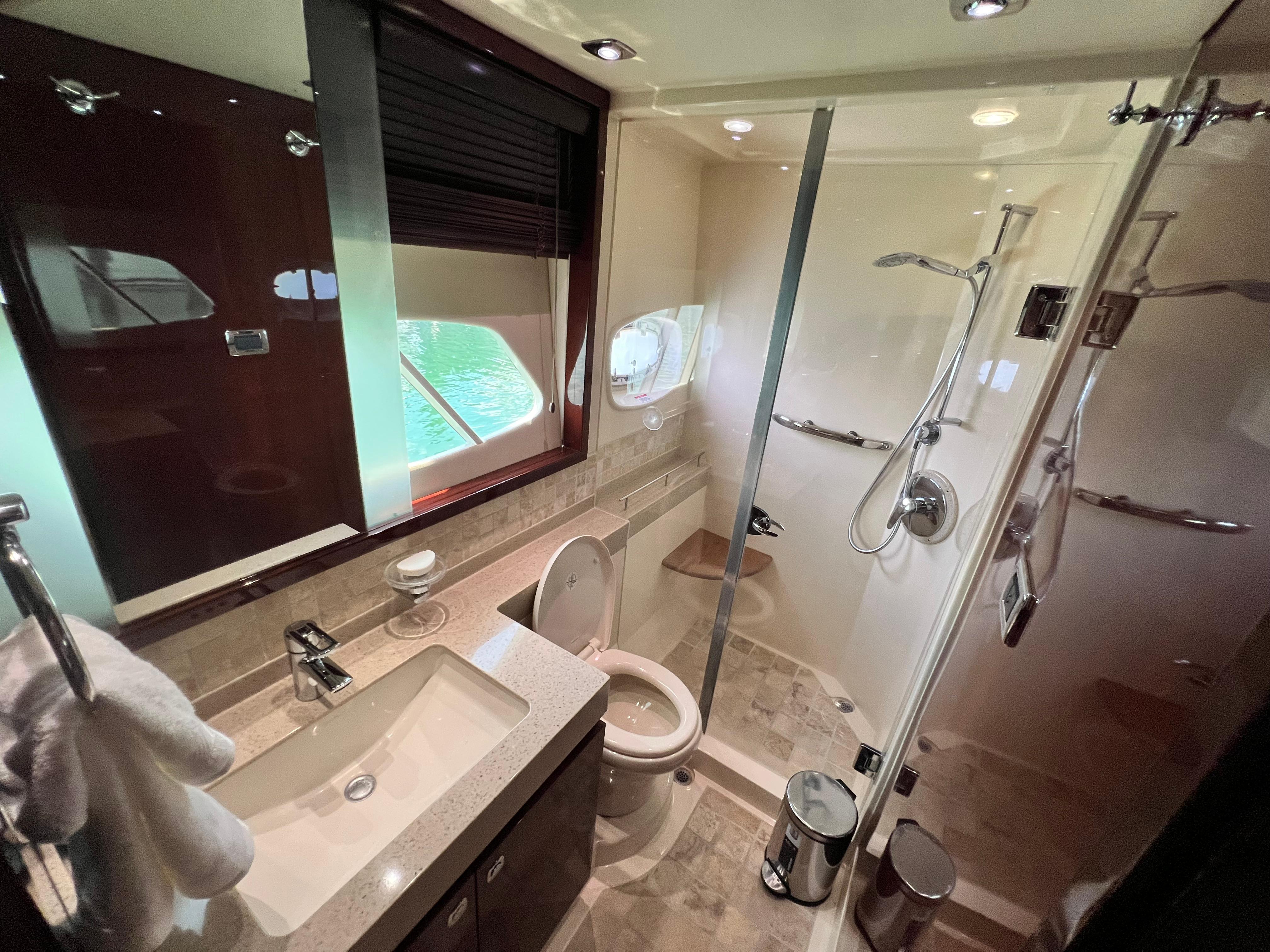 Luxurious bathroom in 2010 Sea Ray 540 Sundancer yacht with modern fixtures and shower.