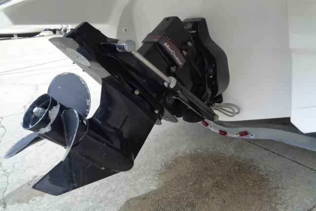 2019 Monterey 218SS Super Sport boat outboard motor close-up on concrete surface.