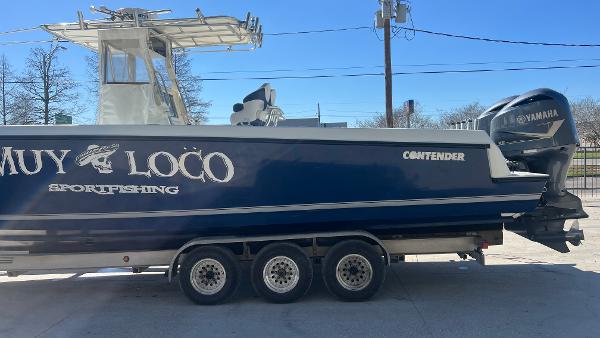 2005 Contender 36 Open sportfishing boat on a trailer with Yamaha outboard engines.