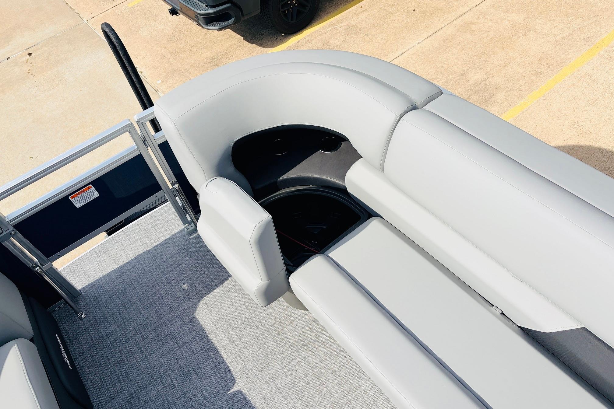 2026 Sun Tracker SportFish 22 DLX pontoon boat with gray seating and carpeted deck.
