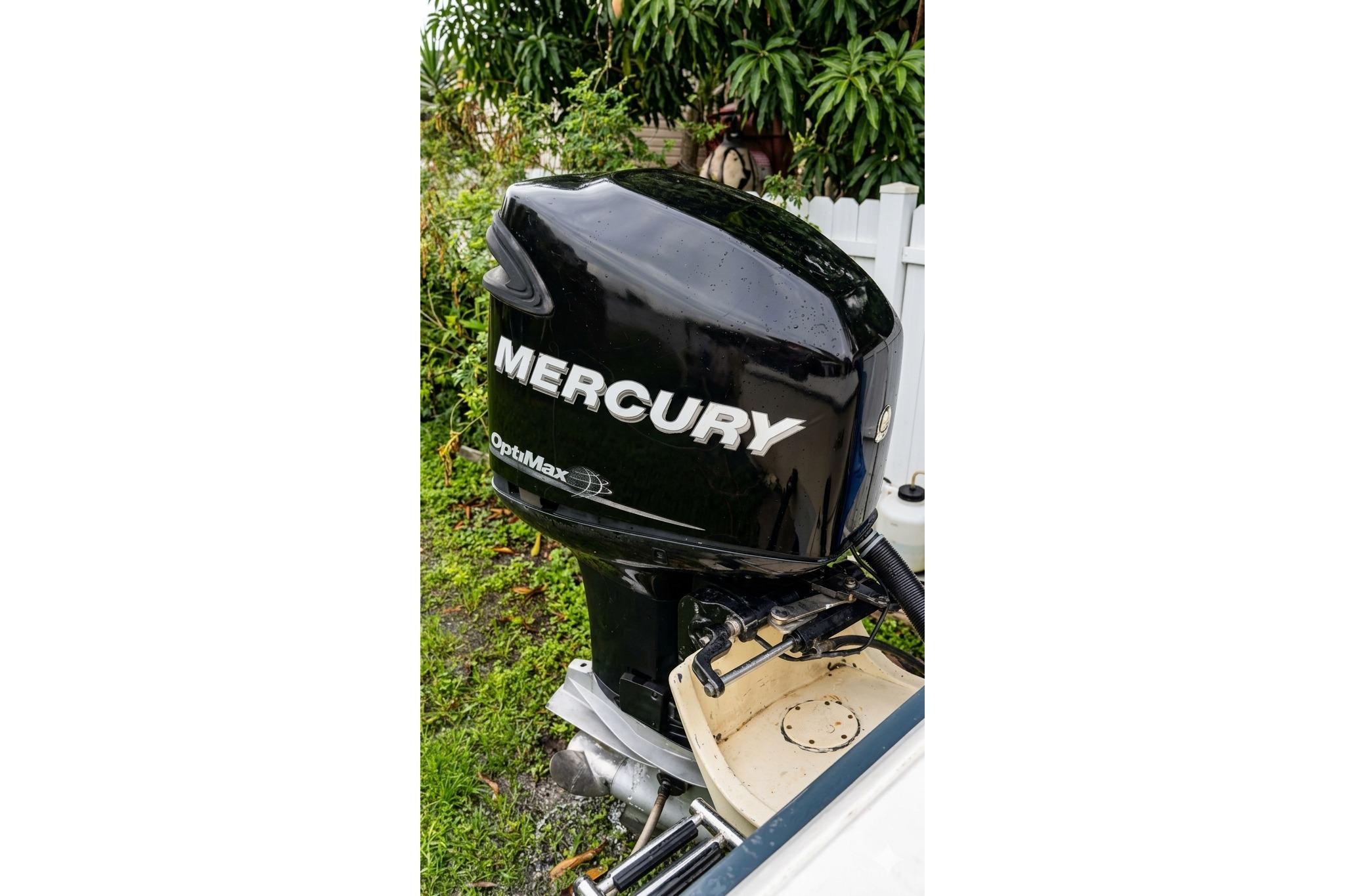 1989 Grady-White Offshore 242 with Mercury OptiMax outboard motor in a garden setting.