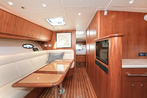 2008 Tiara Yachts 4200 Open interior with wood finish, dining area, and modern amenities.
