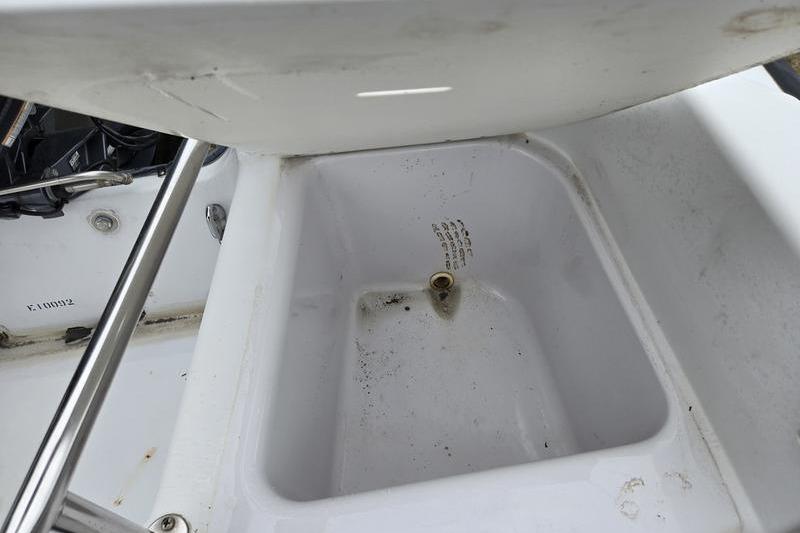 1996 Boston Whaler Outrage 17 boat compartment, open and empty, showing interior details.