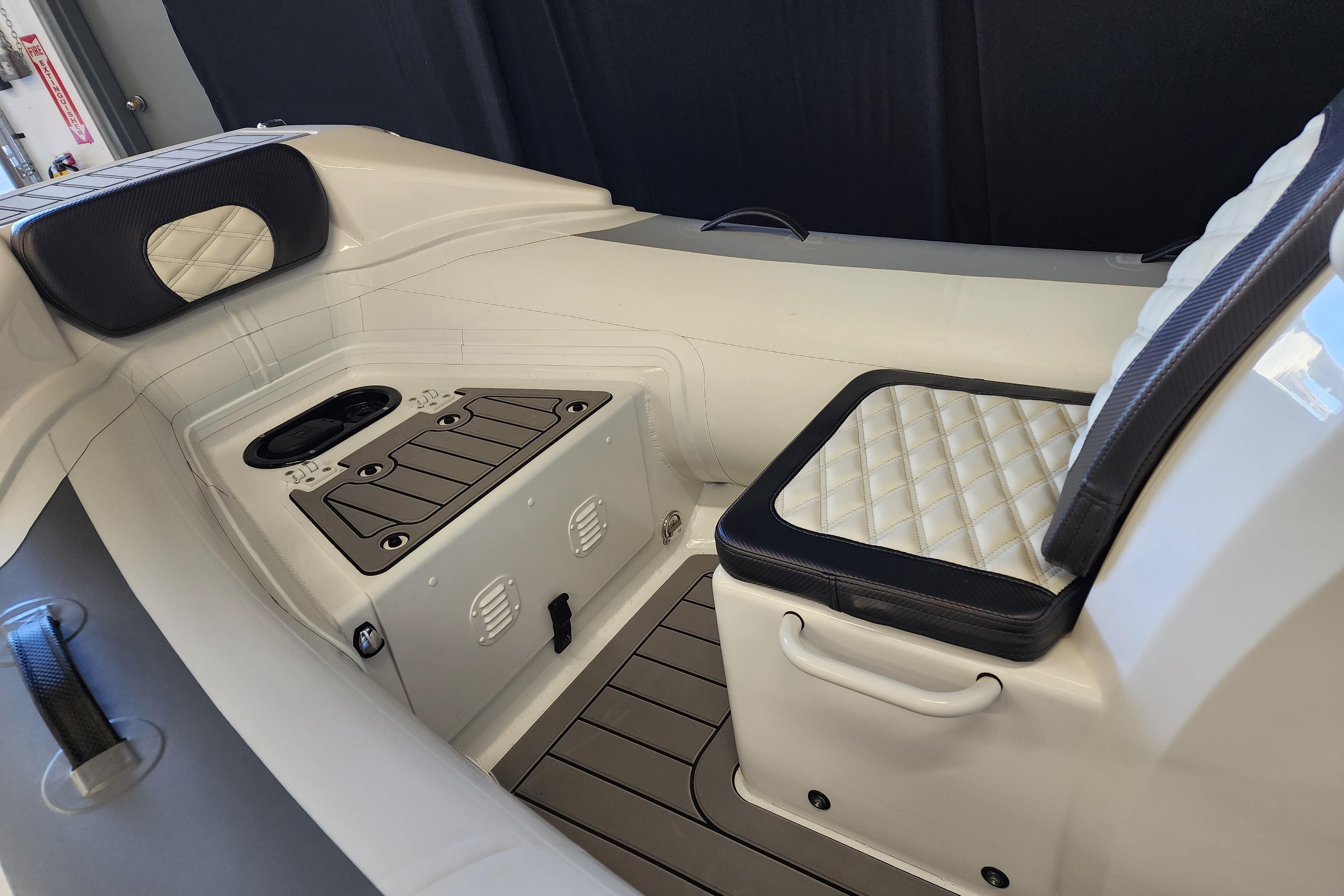 Interior of 2025 Highfield Sport 390 boat with cushioned seating and storage compartments.