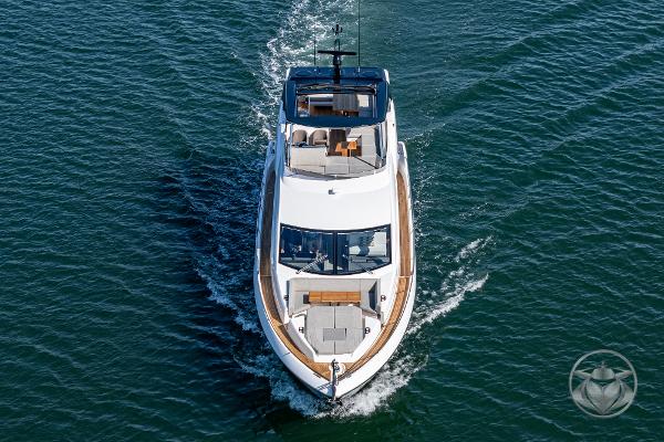 2025 Sunseeker Manhattan 68 yacht cruising on open water, aerial view.