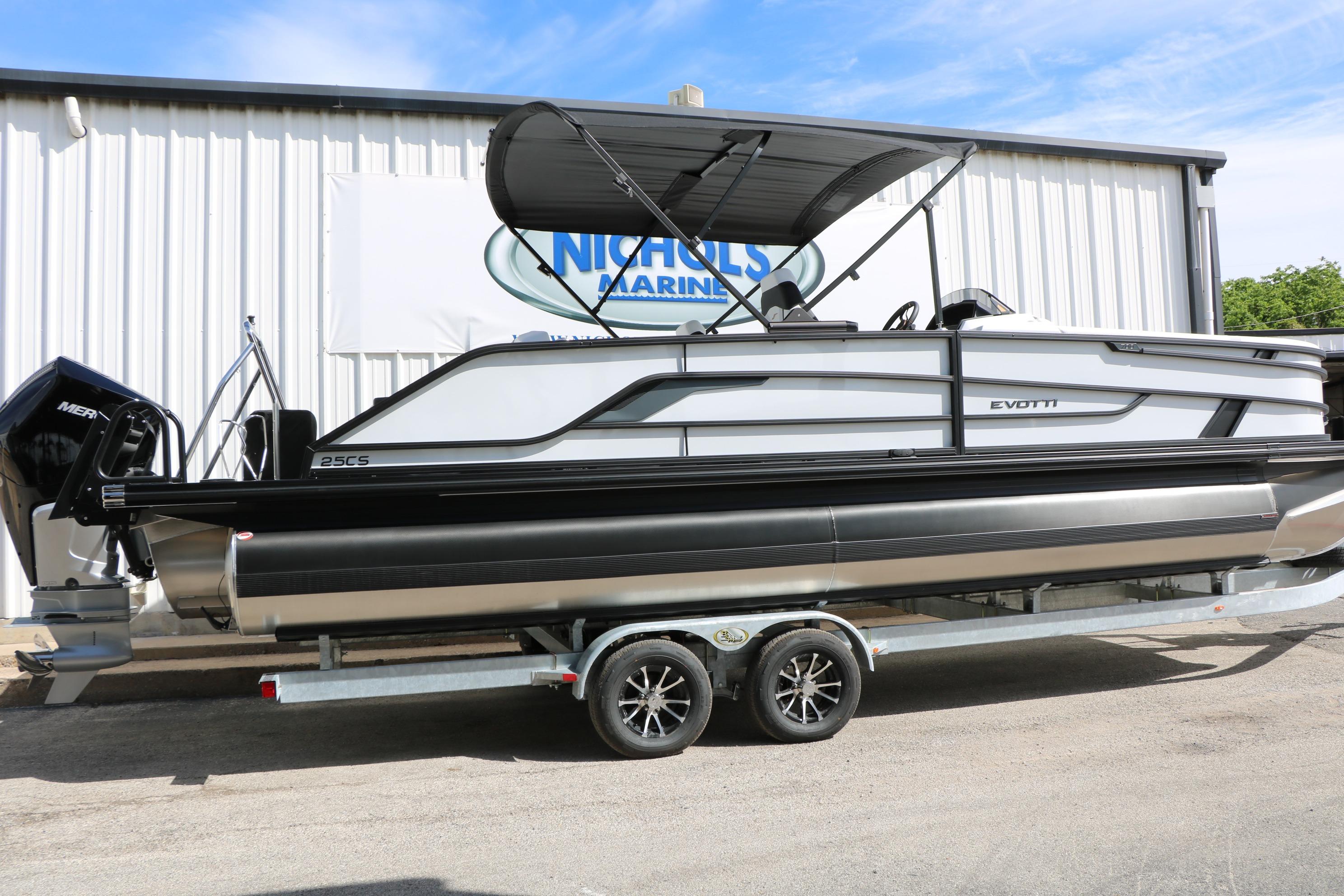 2026 Evotti 725 CS Tri-Toon boat on trailer, parked outside Nichols Marine.