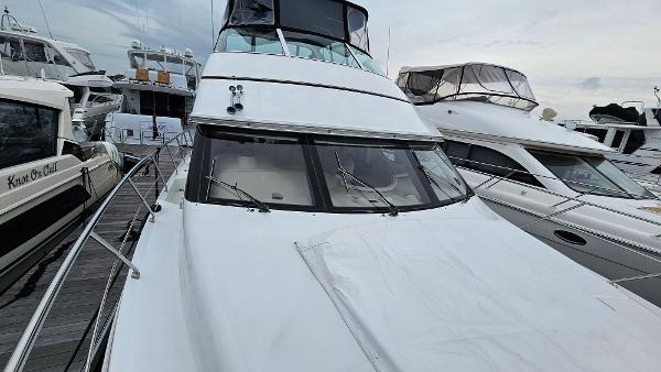 2000 Carver 450 Voyager Pilothouse yacht docked among other boats.