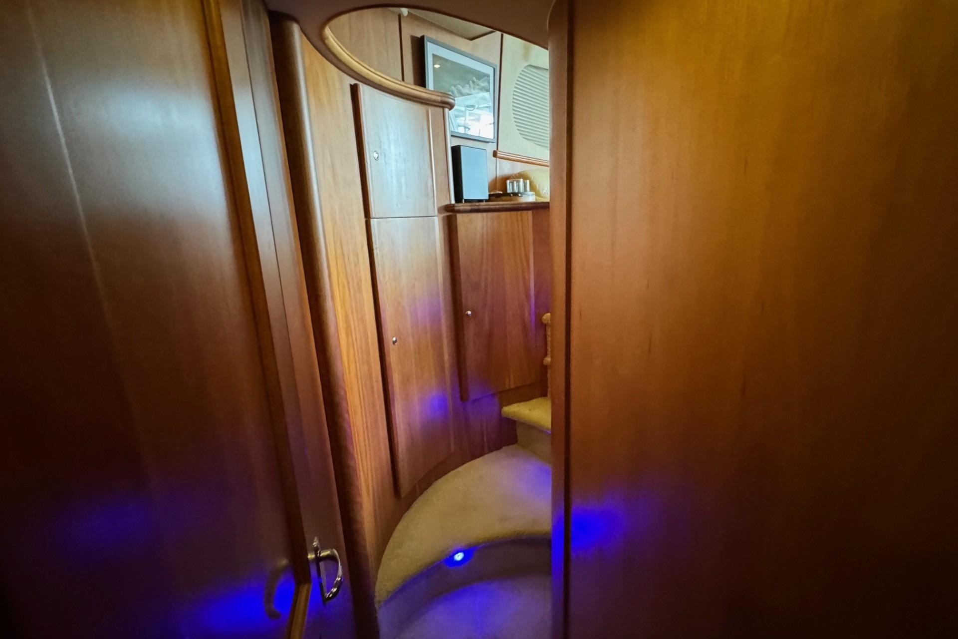 Interior of 2003 Silverton 410 Sport Bridge with wooden paneling and blue accent lighting.