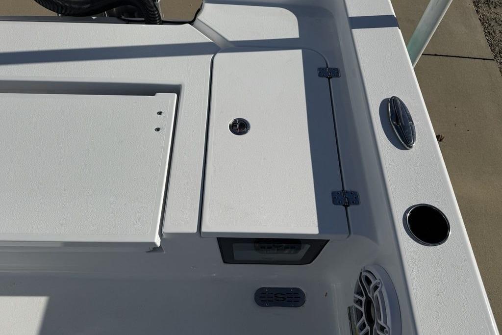 2026 Sportsman Masters 247OE Bay Boat deck with storage compartments and speaker.