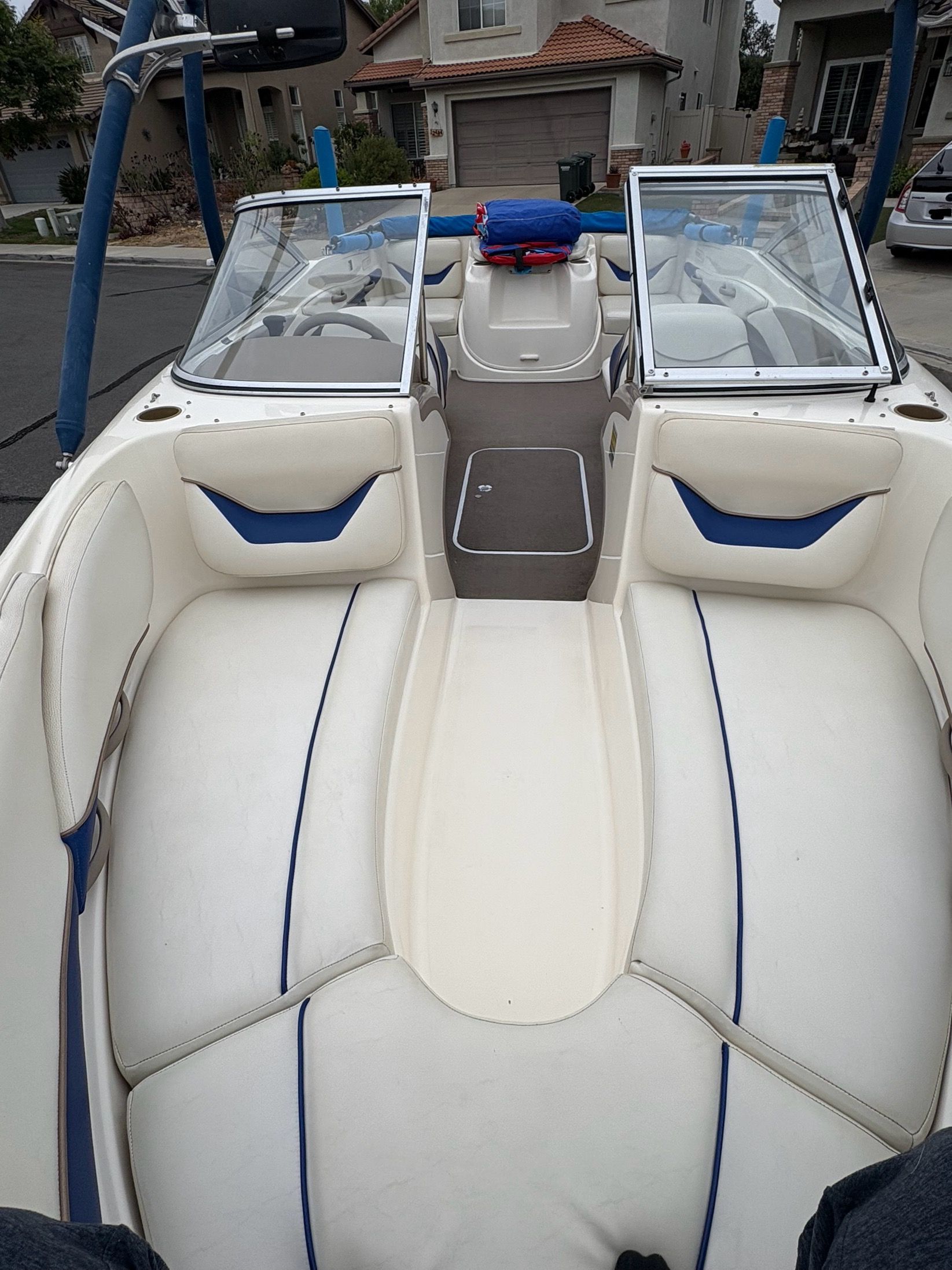 2003 Bayliner CAPRI 205 boat interior with white and blue seating.