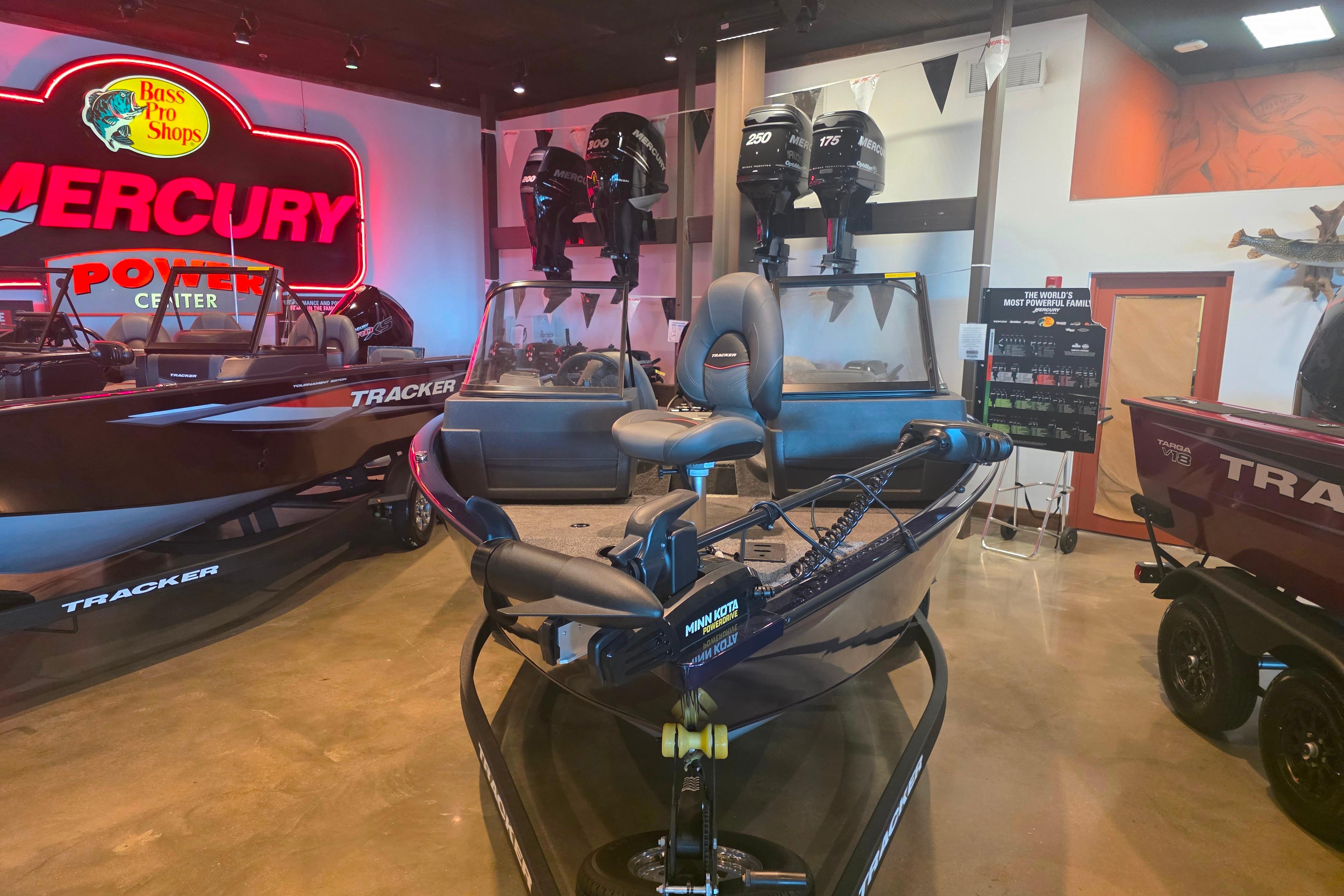 2026 Tracker Pro Guide V-175 Combo boat displayed at Bass Pro Shops showroom.