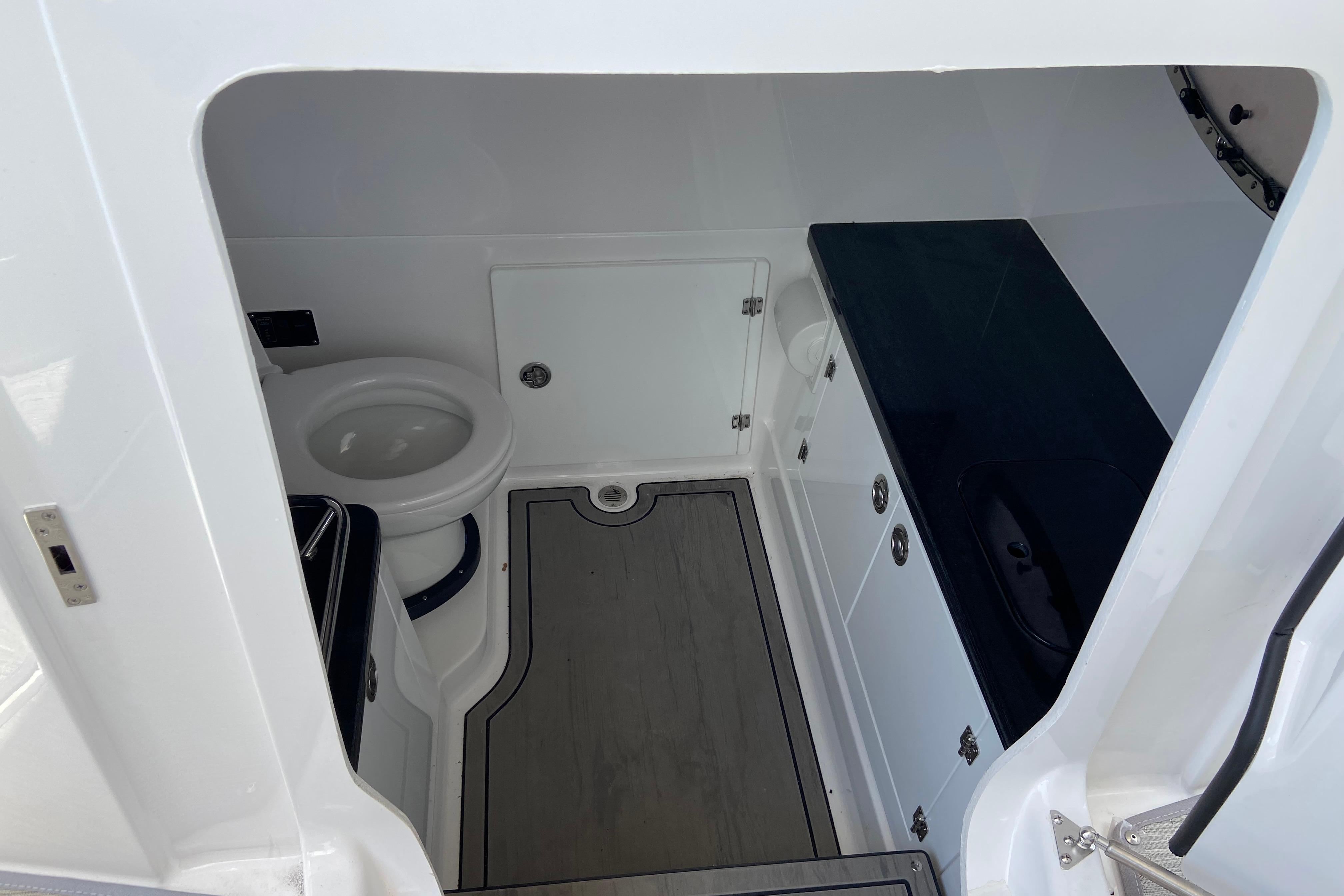 2026 Monterey Elite 30 OB boat interior with toilet and storage cabinets.