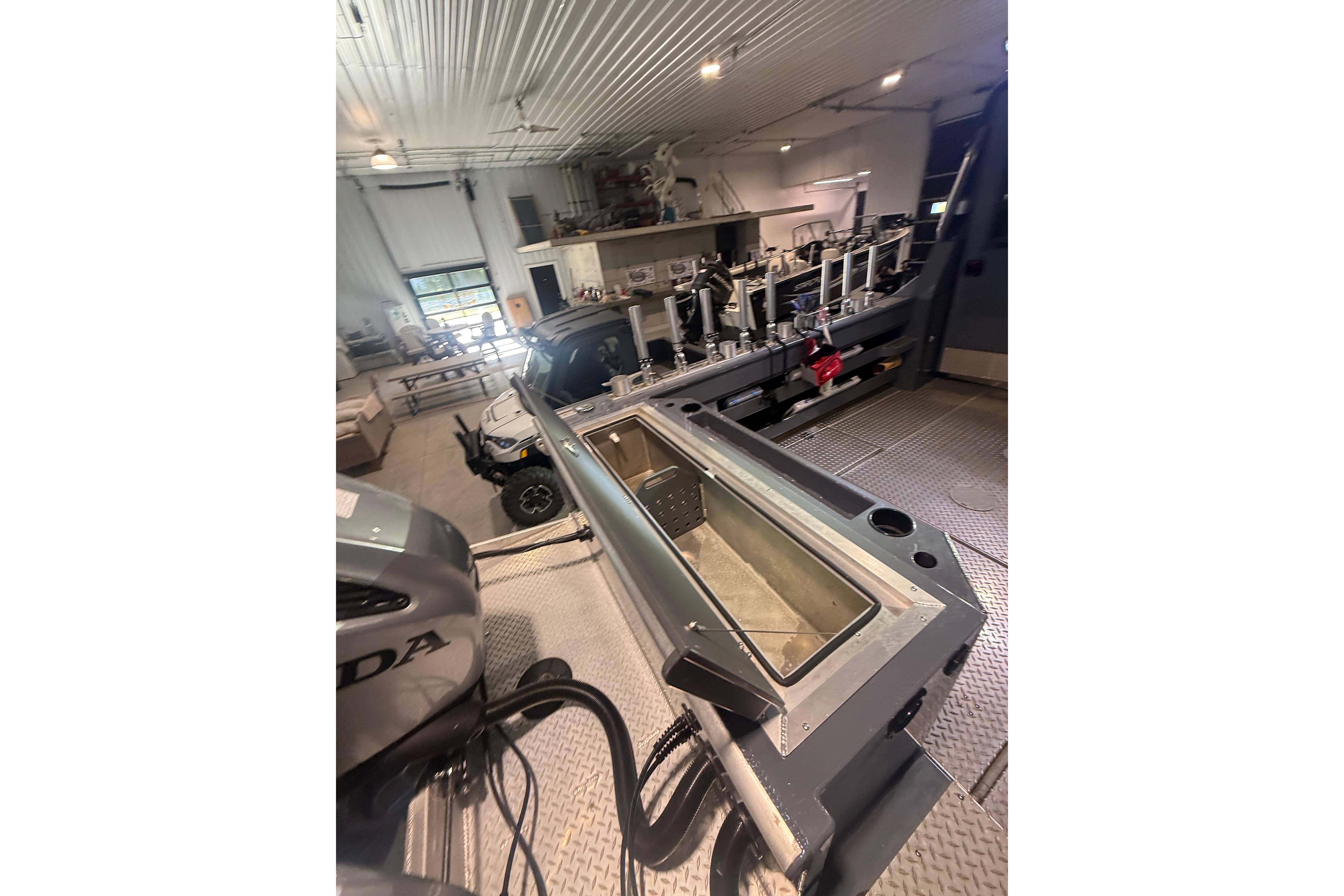 2022 Hewescraft 270 Alaskan Hardtop in a workshop, showcasing interior and equipment.