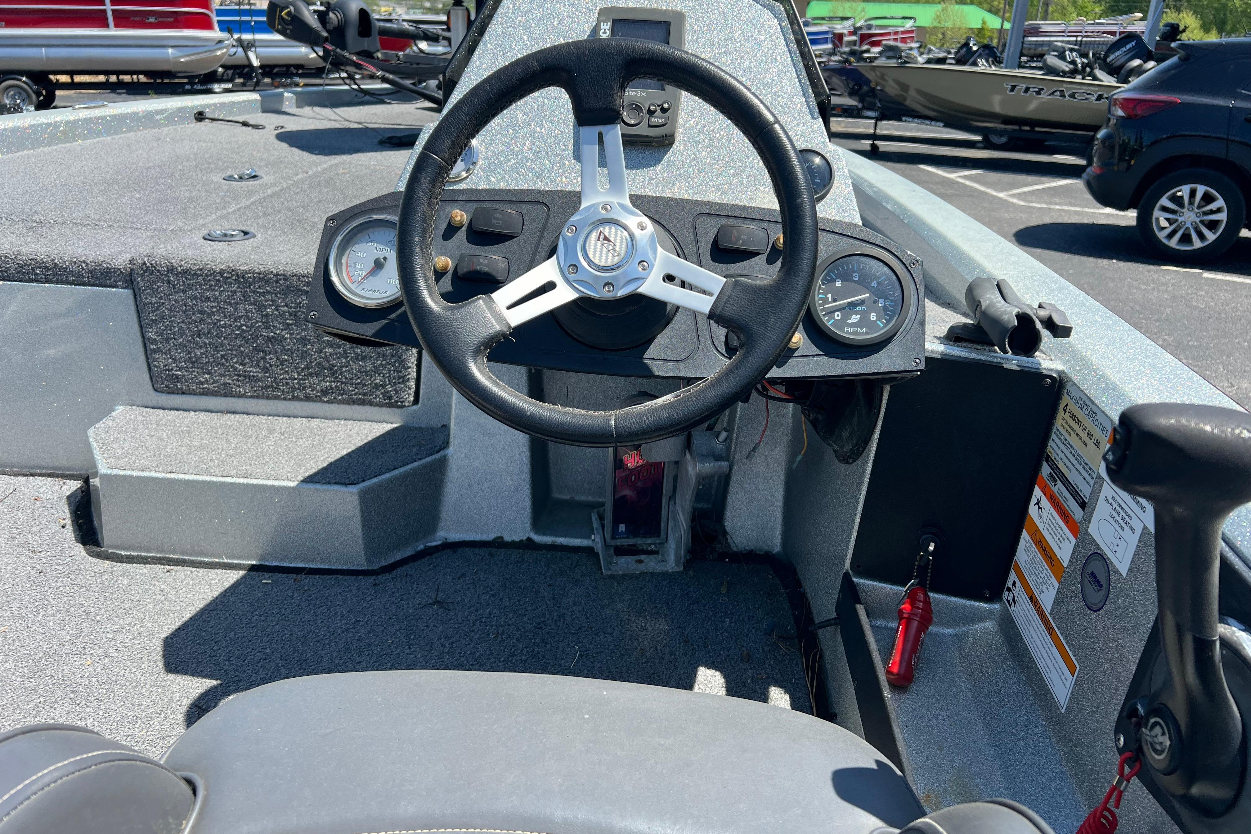 Steering console of a 2015 Stratos 186 VLO boat, featuring gauges and controls.