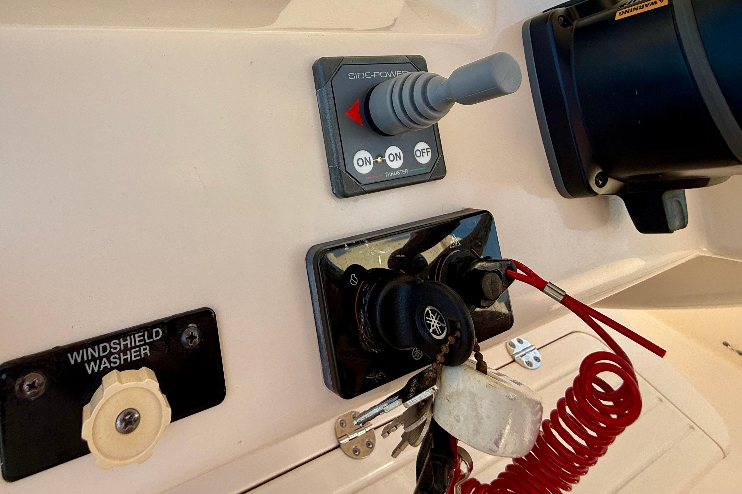 Control panel of a 2012 Grady-White Canyon 336 boat with keys and switches.