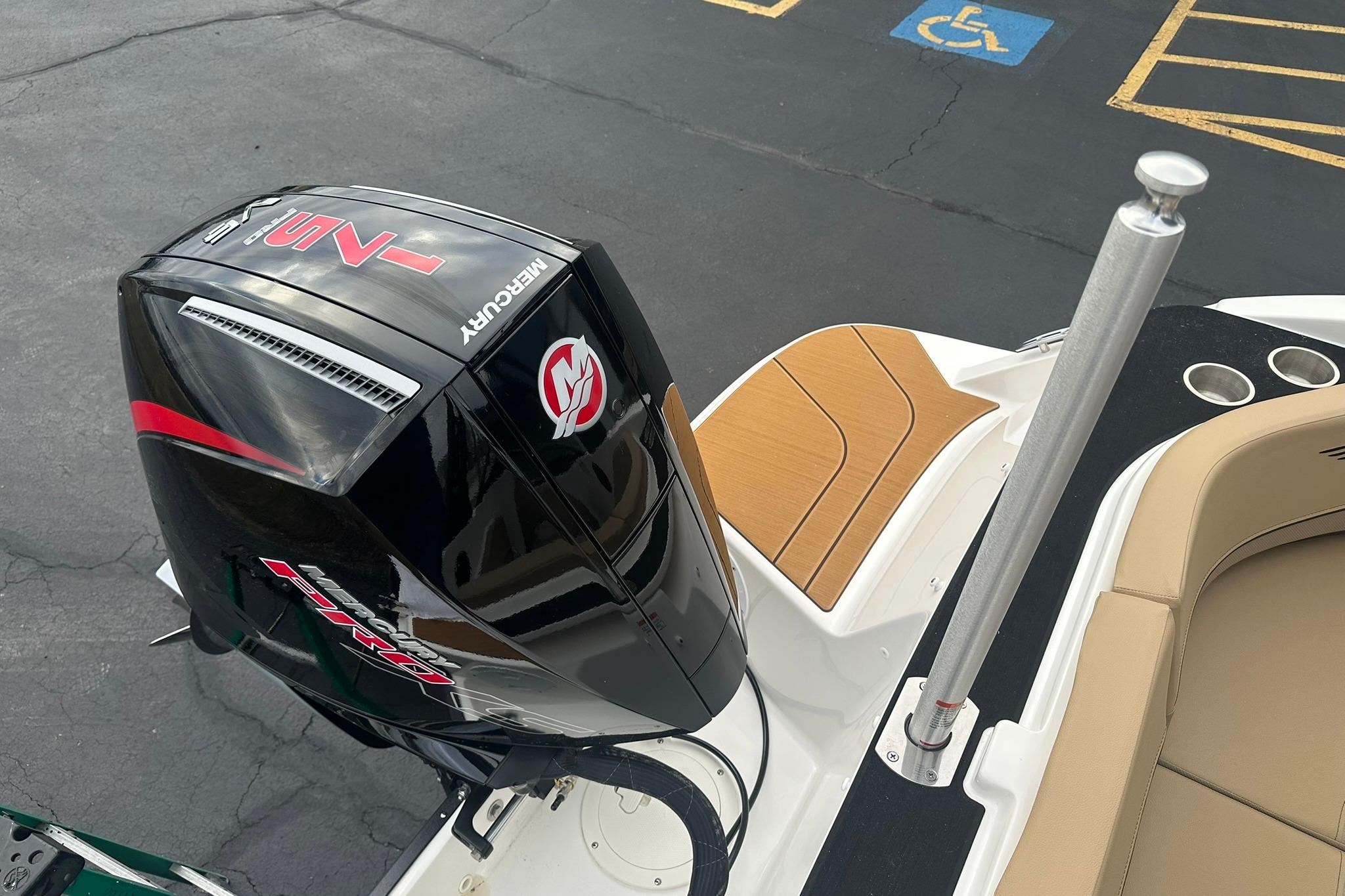 2026 Bayliner V20 boat with Mercury outboard motor, docked in a parking area.