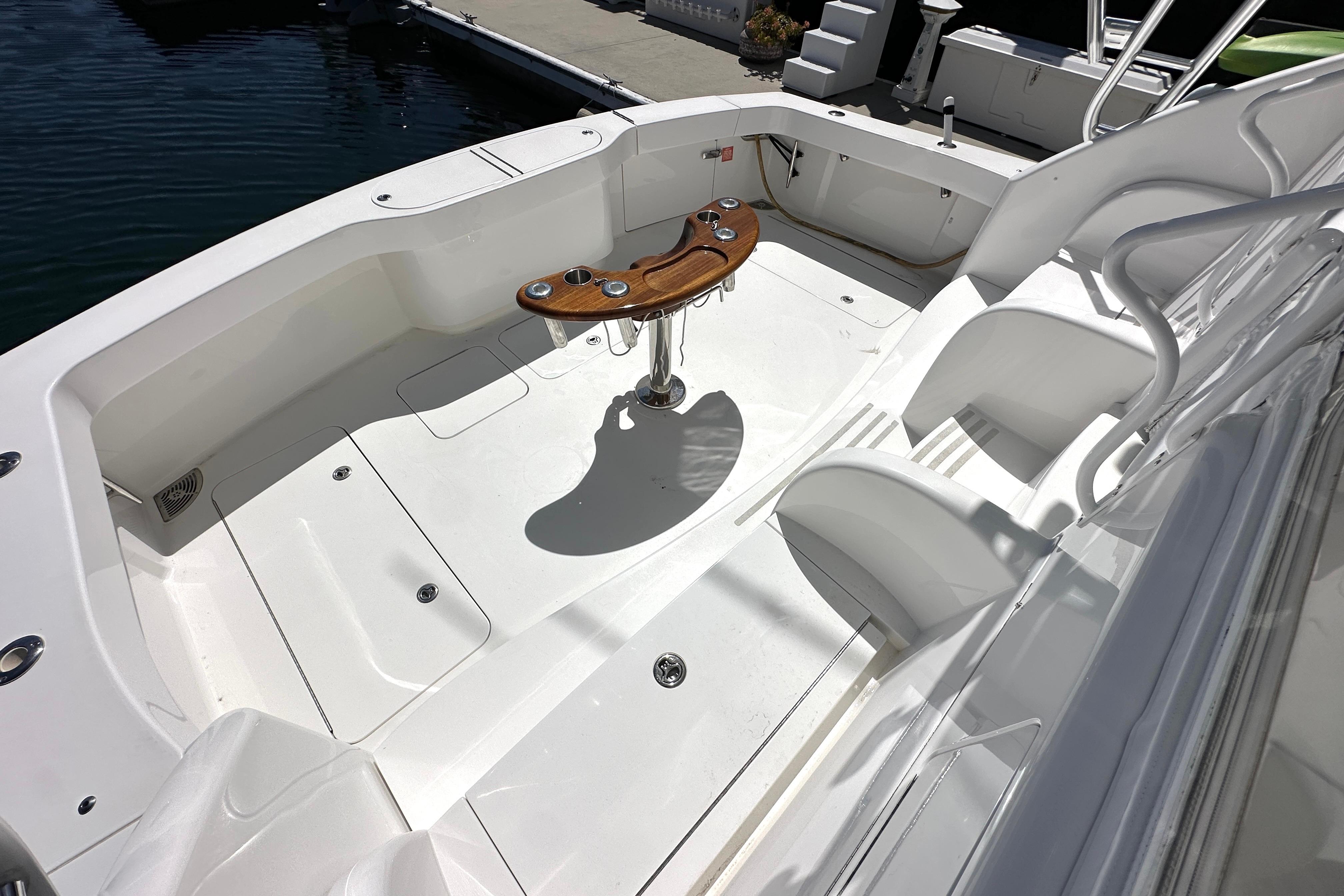 2012 Viking 42 Open boat deck with seating and wooden table.