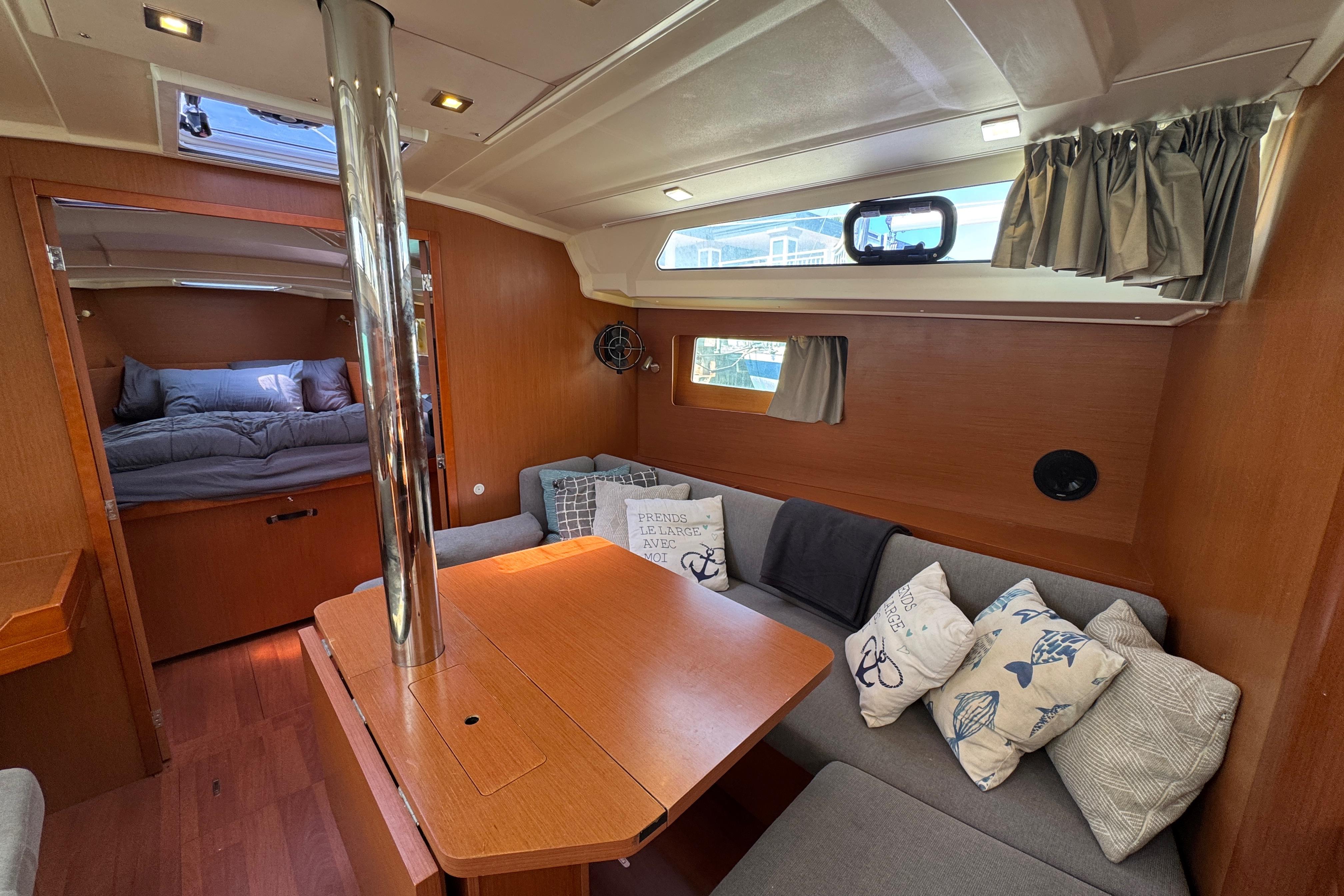 Interior of 2017 Beneteau Oceanis 41.1 yacht with cozy seating and wooden finishes.
