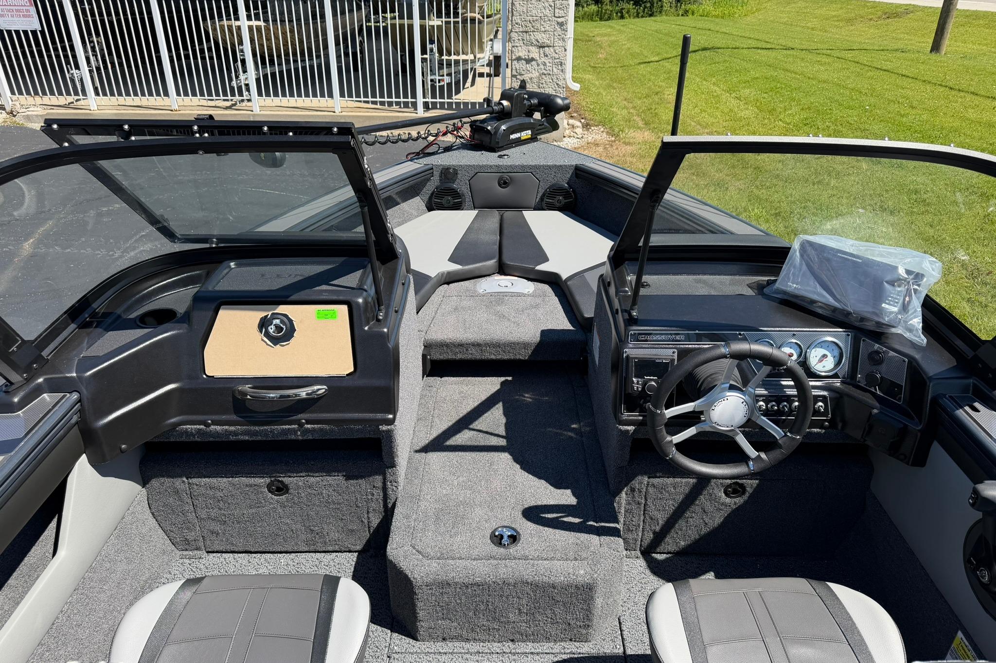 Interior view of 2027 Lund 1775 Crossover XS boat, featuring steering wheel and dashboard controls.