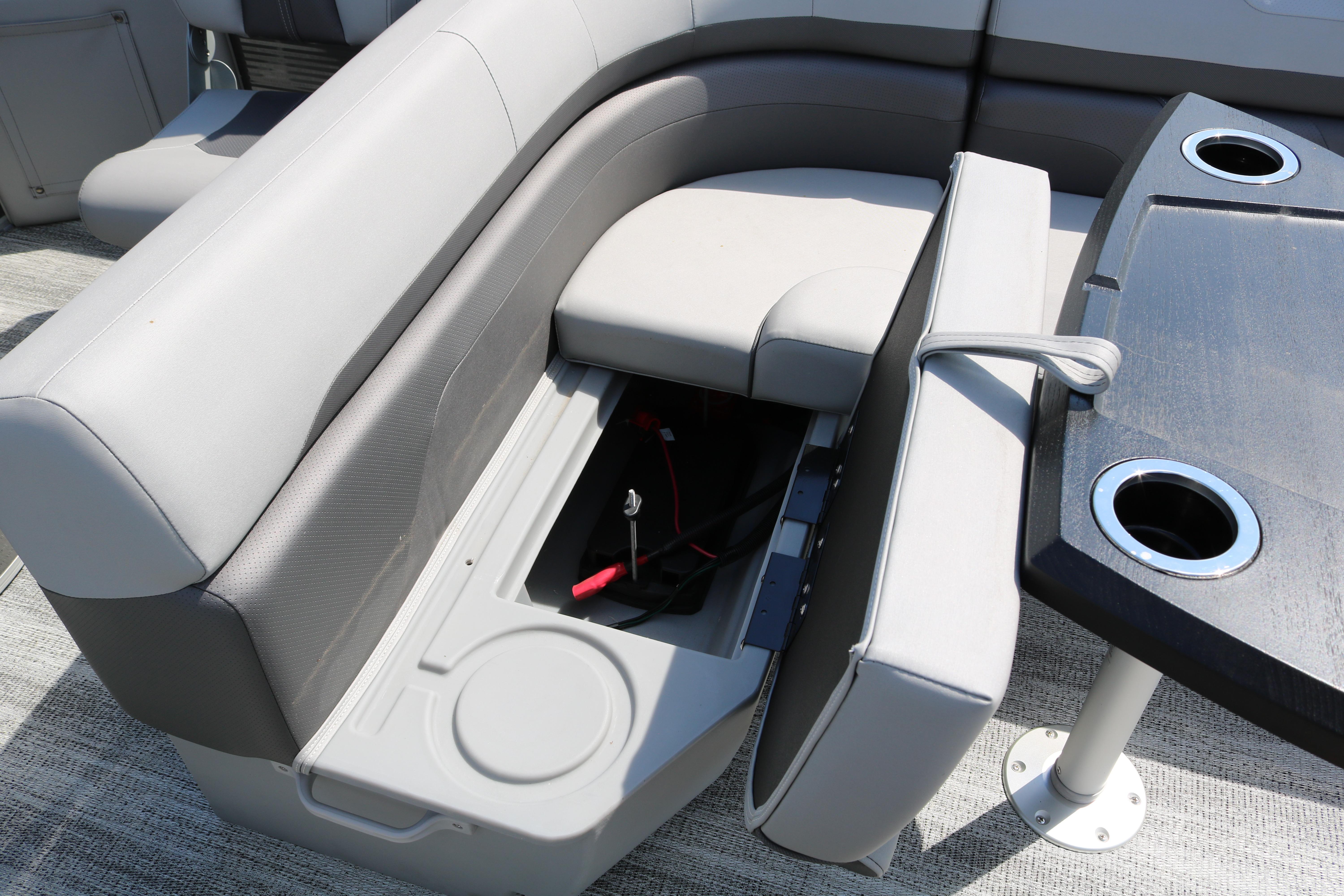 2026 Bennington 20SXSNP REAR FISH boat interior with storage compartment and cup holders.