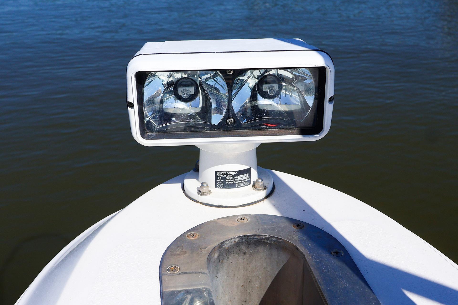 Spotlight on 1998 Sea Ray 500 Sundancer boat, positioned on calm water.