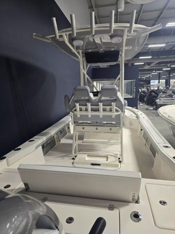 2025 Avenger Boats AV26 interior with seating and T-top in showroom.