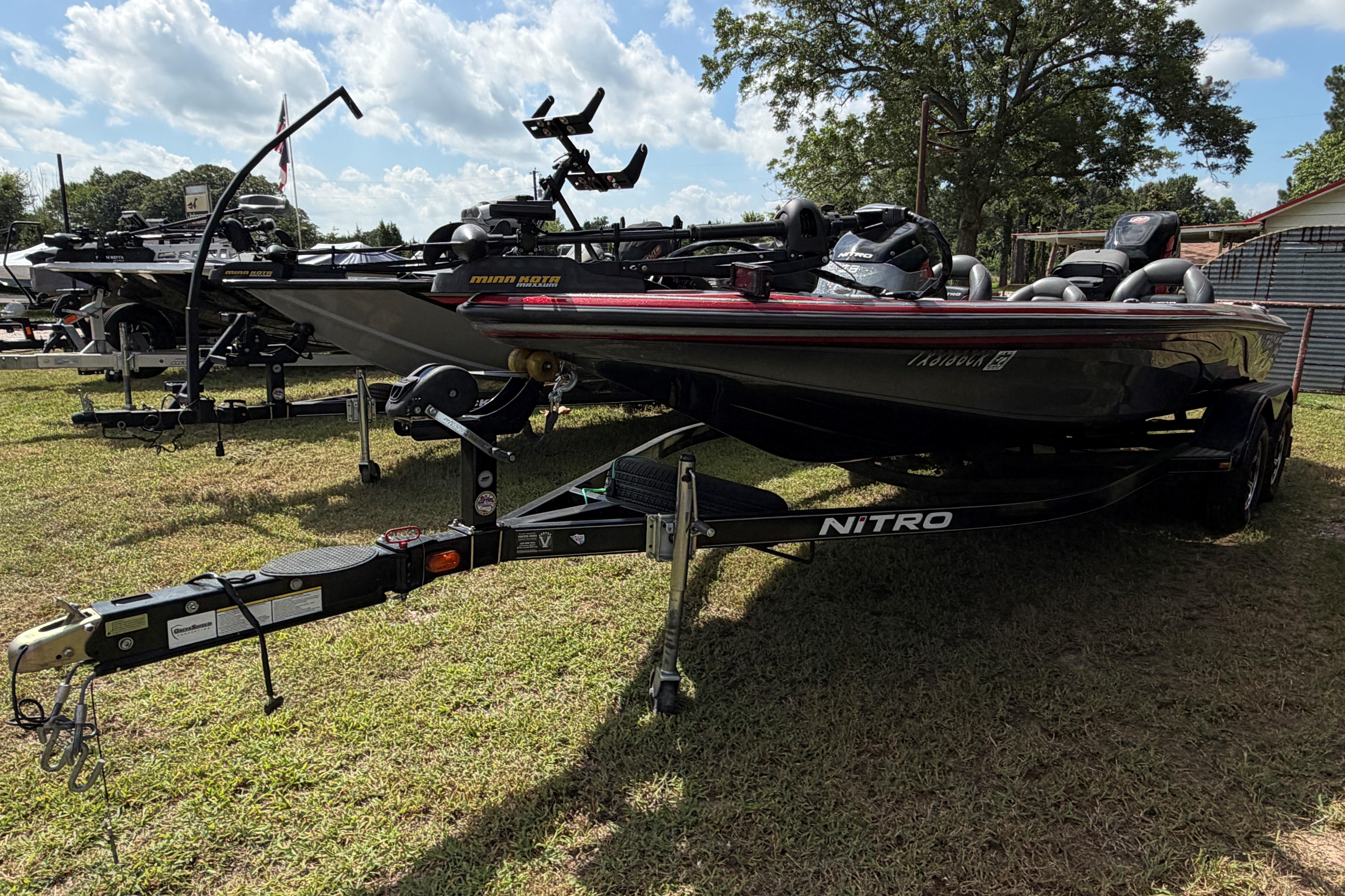 2015 Nitro Z-8 boat on trailer, parked on grass under a partly cloudy sky.