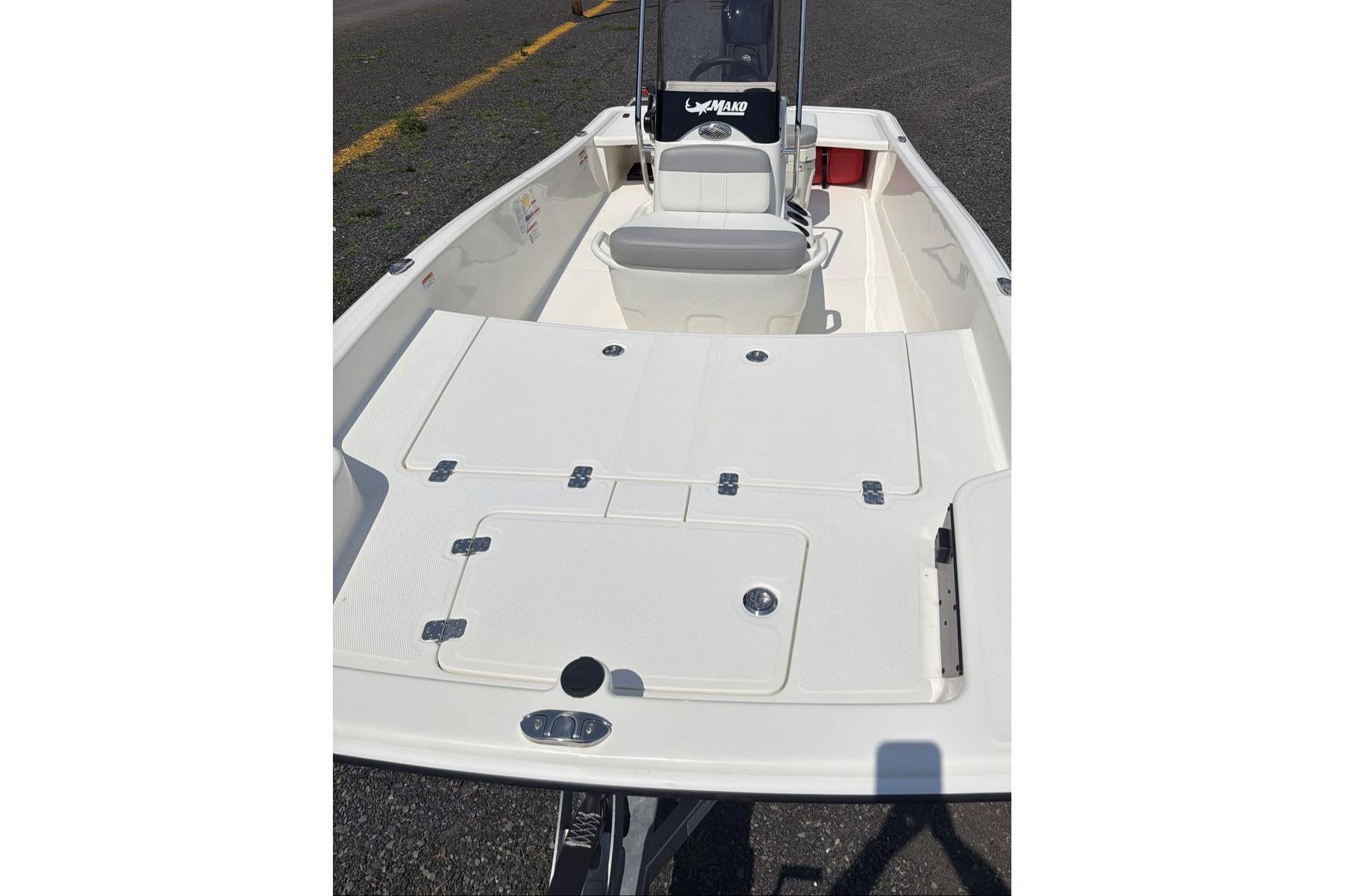 2026 Mako Pro Skiff 15 CC boat interior with seating and storage compartments.