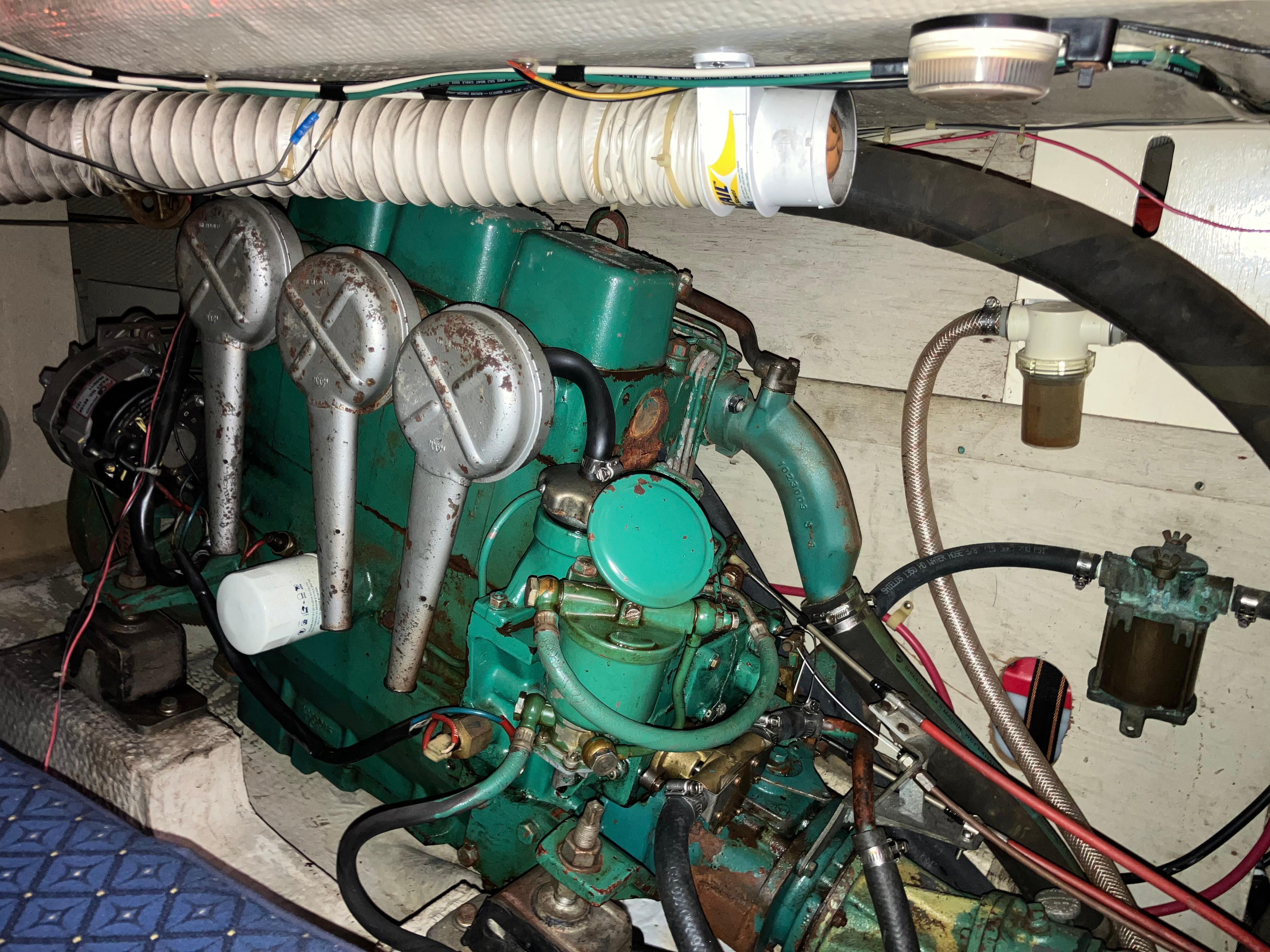 1981 S2 11.0A engine compartment with green marine engine and wiring.
