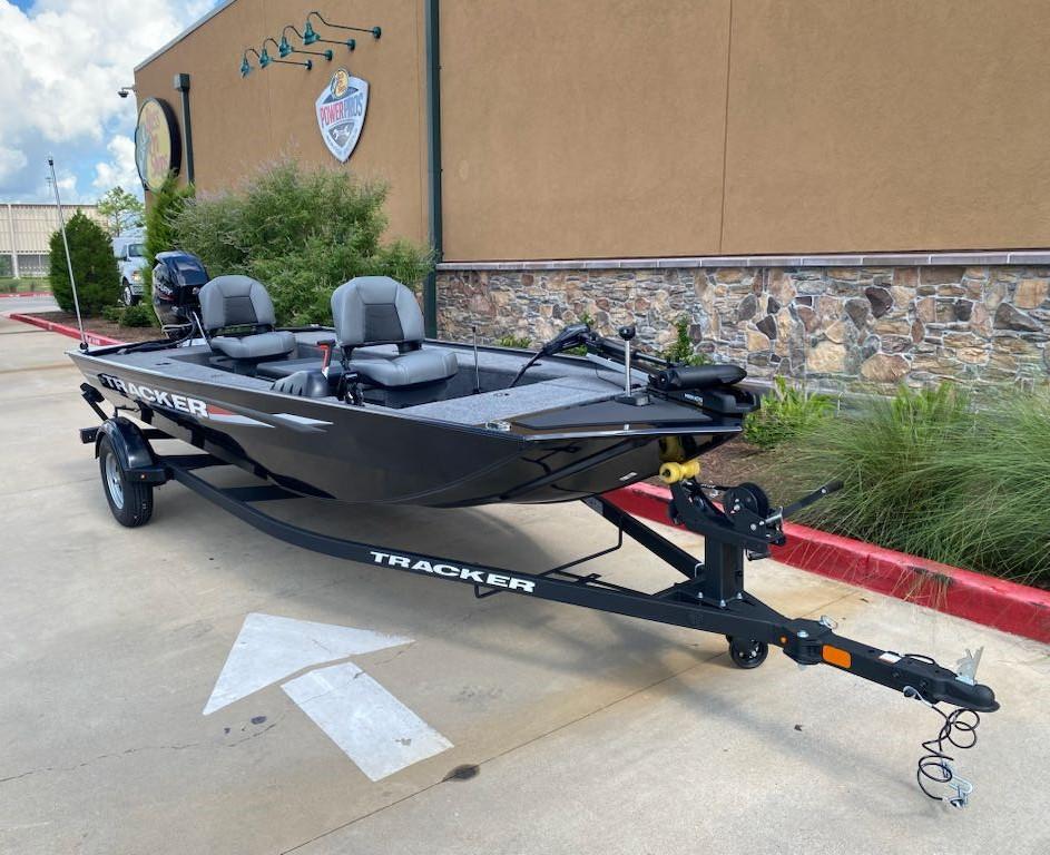 2025 Tracker Panfish 17 boat on trailer, parked outdoors near a building.