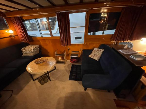 1951 Chris-Craft Catalina interior with cozy seating, wooden paneling, and ambient lighting.