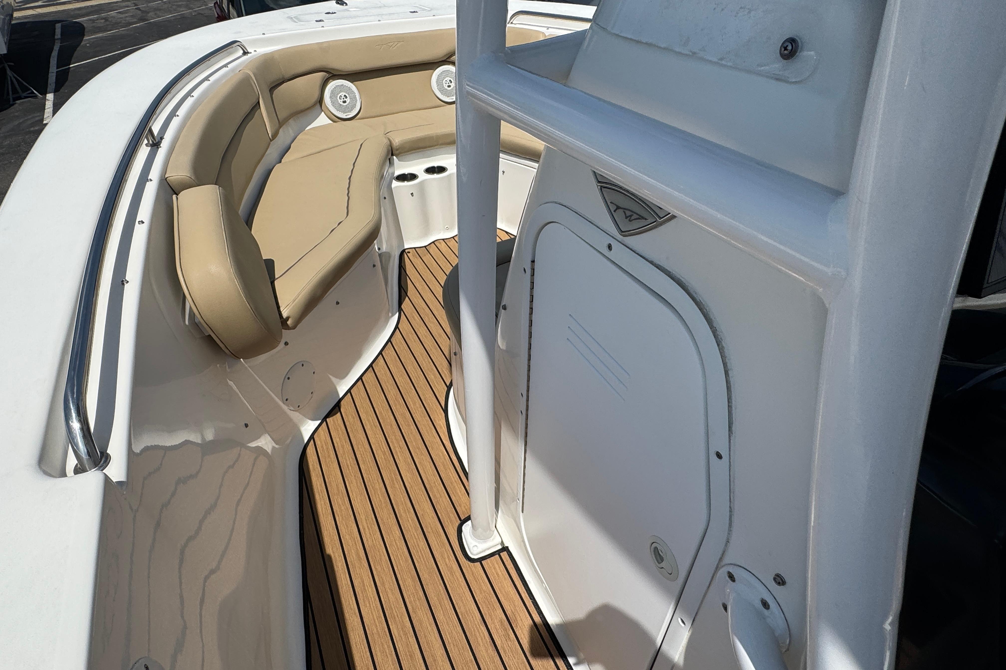 2016 Tidewater 230 LXF boat interior with tan seating and wood-style flooring.