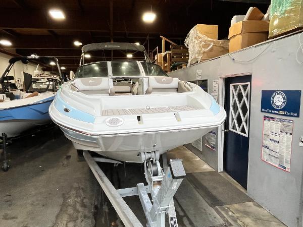 2023 Crownline Eclipse E235 XS boat in indoor storage on a trailer.