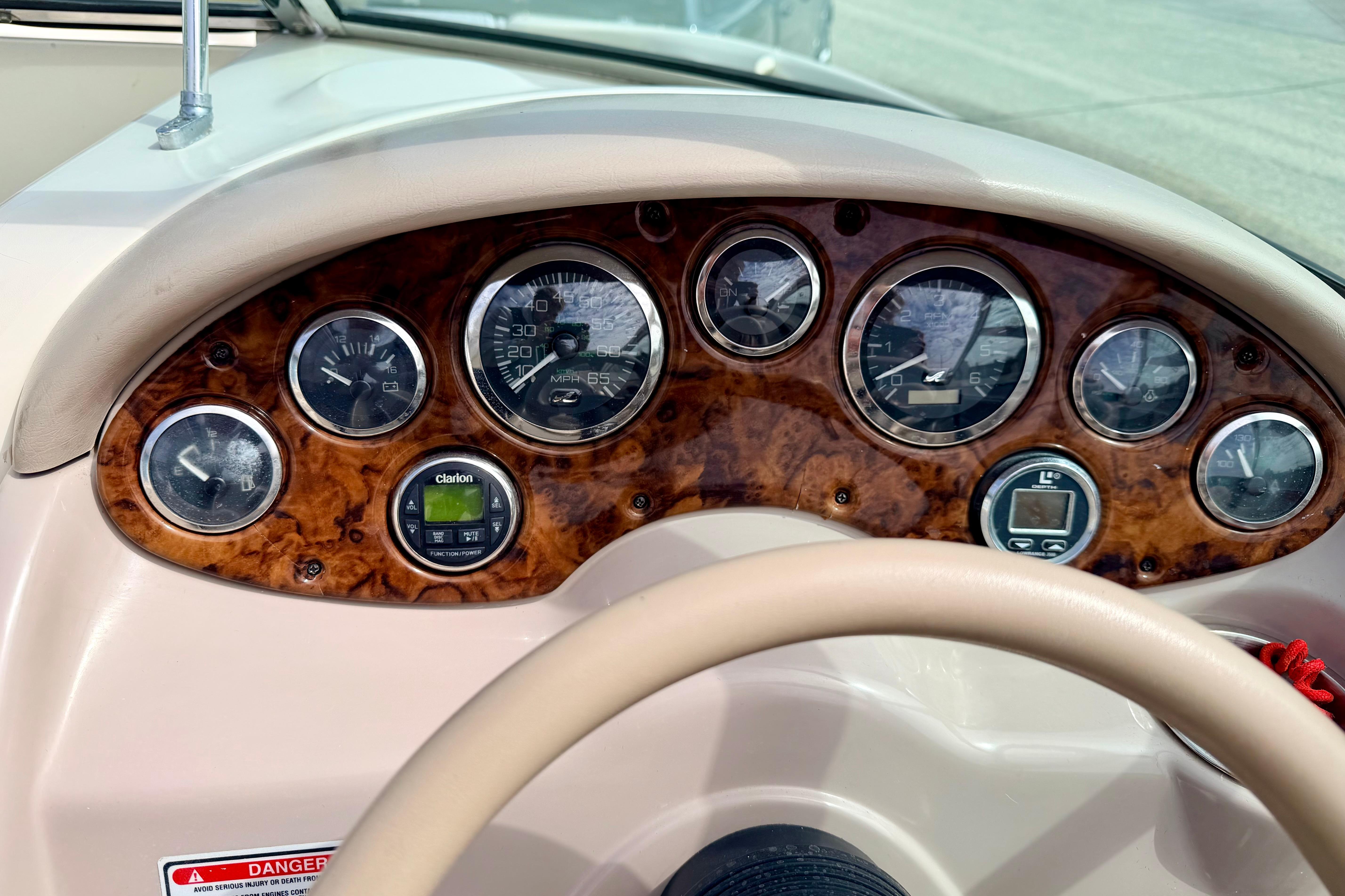 Dashboard of a 2003 Sea Ray 200 Sundeck boat with gauges and controls.