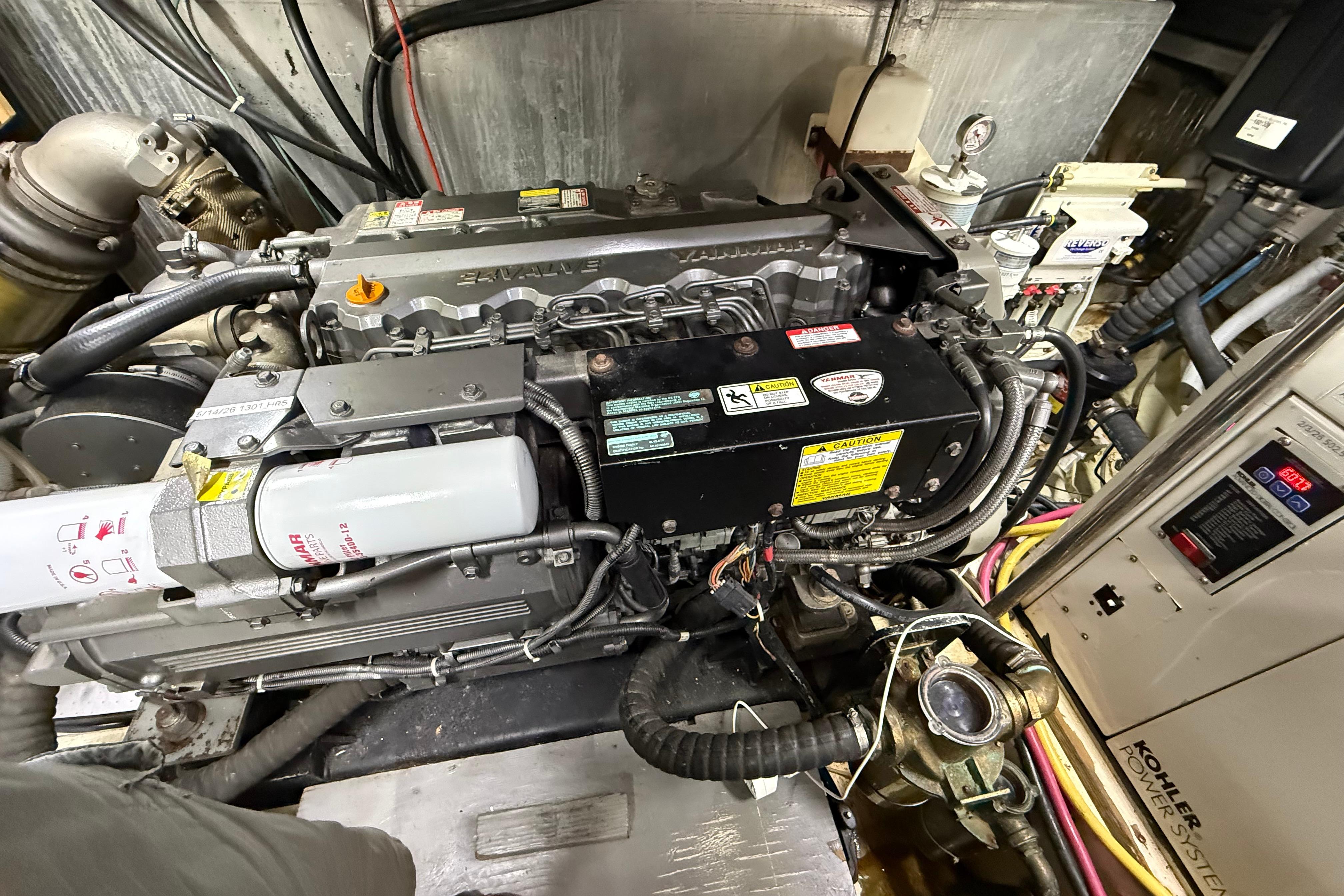 Engine room of a 2006 Carver 43 Motor Yacht, showcasing detailed machinery and components.