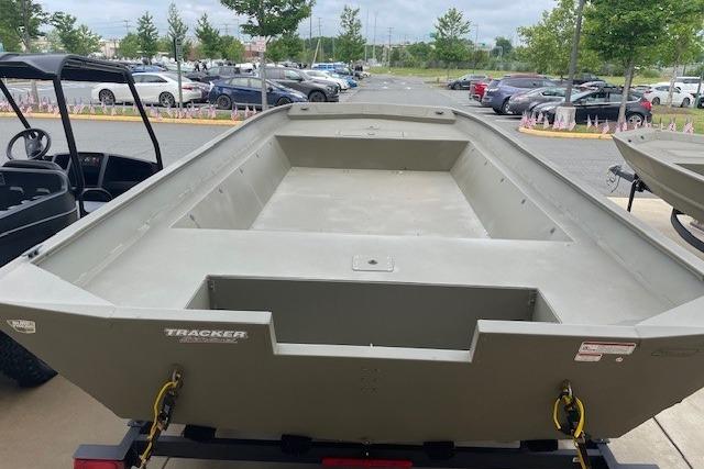 2025 Tracker Grizzly 2072 Utility boat on trailer in outdoor parking lot.