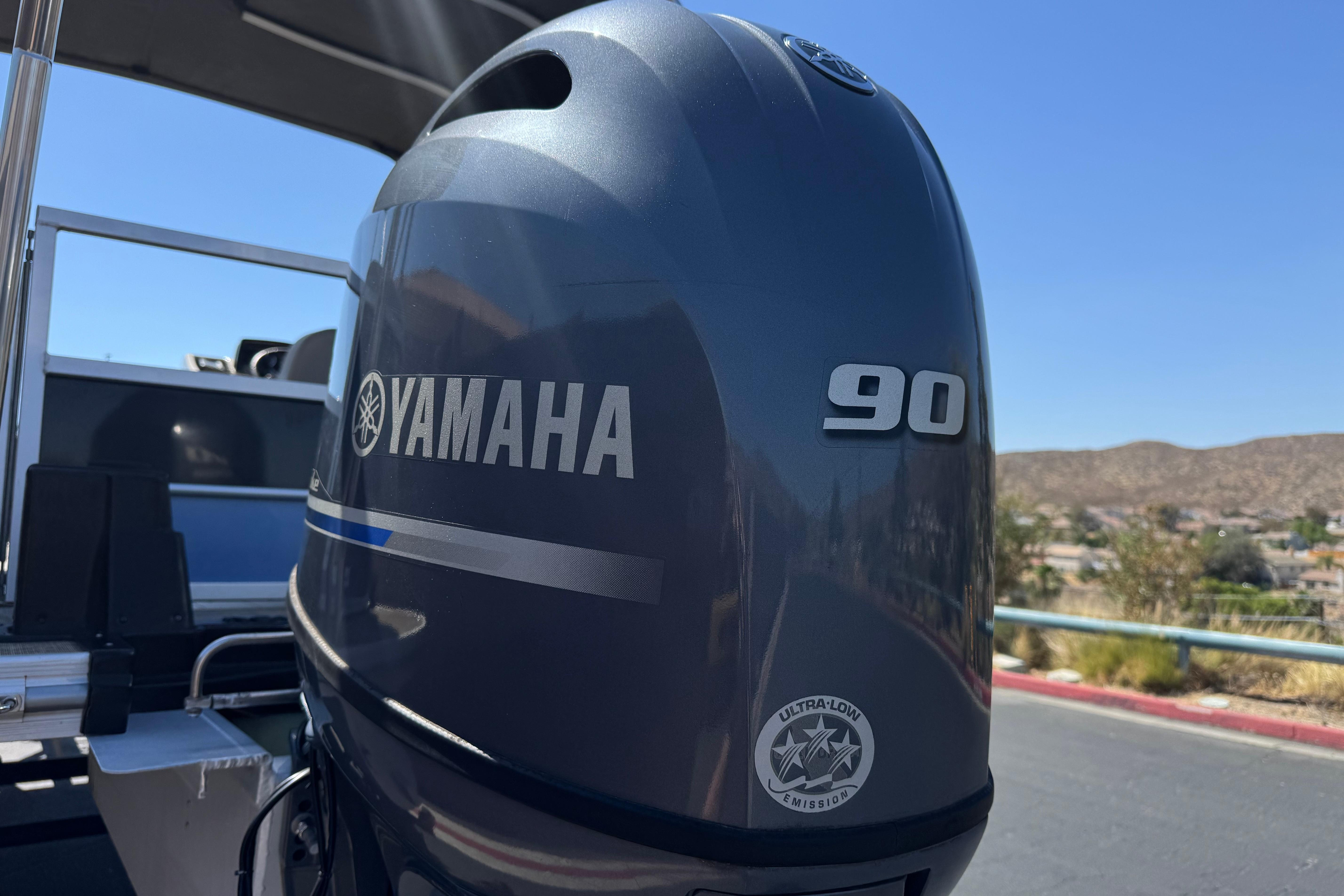 Yamaha 90 outboard motor on 2021 SunCatcher Select 20RCX boat, sunny day.
