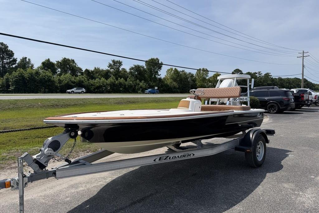 2012 Chaos 16 Bonefish boat on trailer, parked outdoors under clear sky.