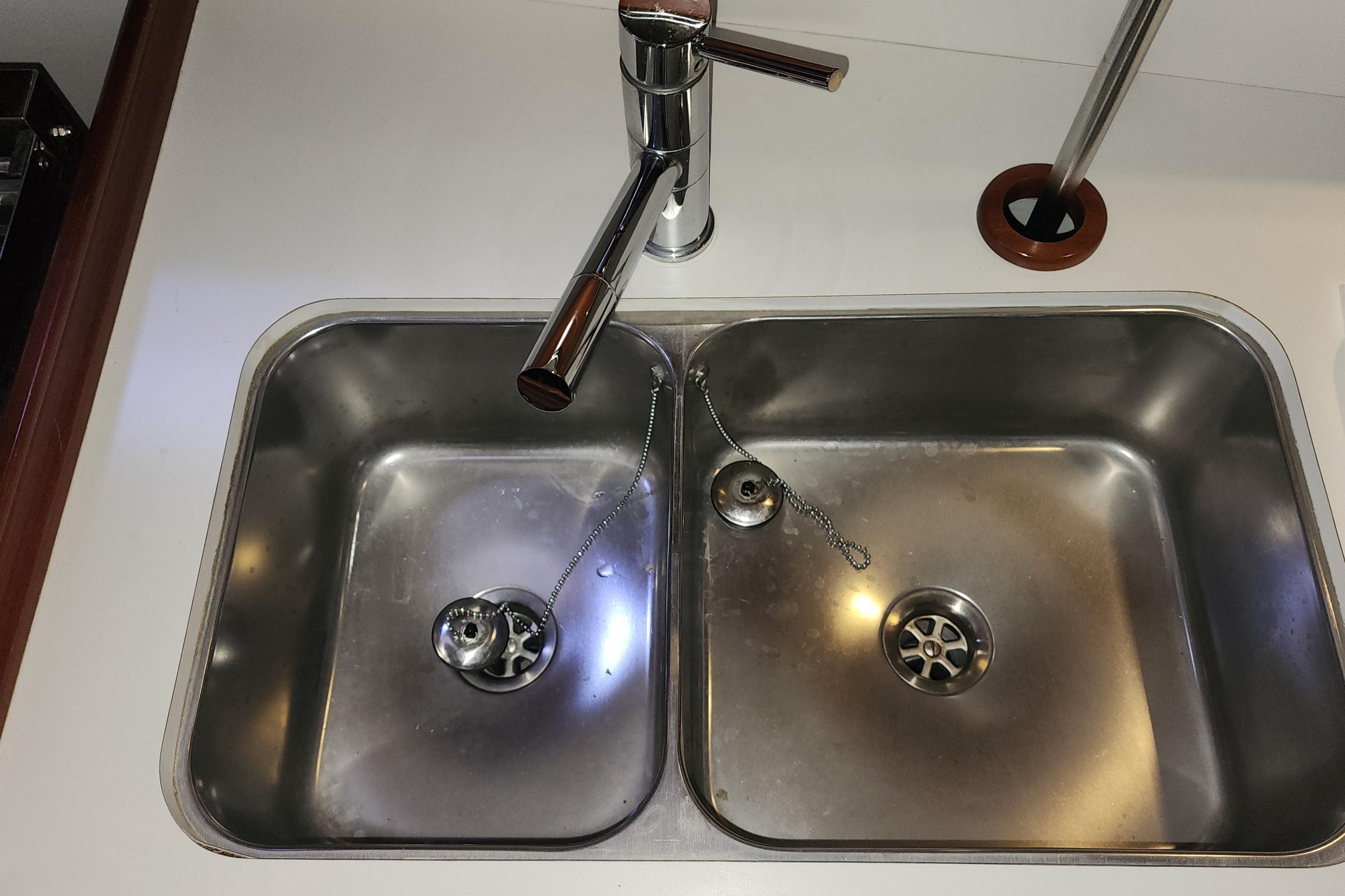 Stainless steel double sink on 2012 Beneteau Oceanis 40 yacht, featuring modern faucet design.