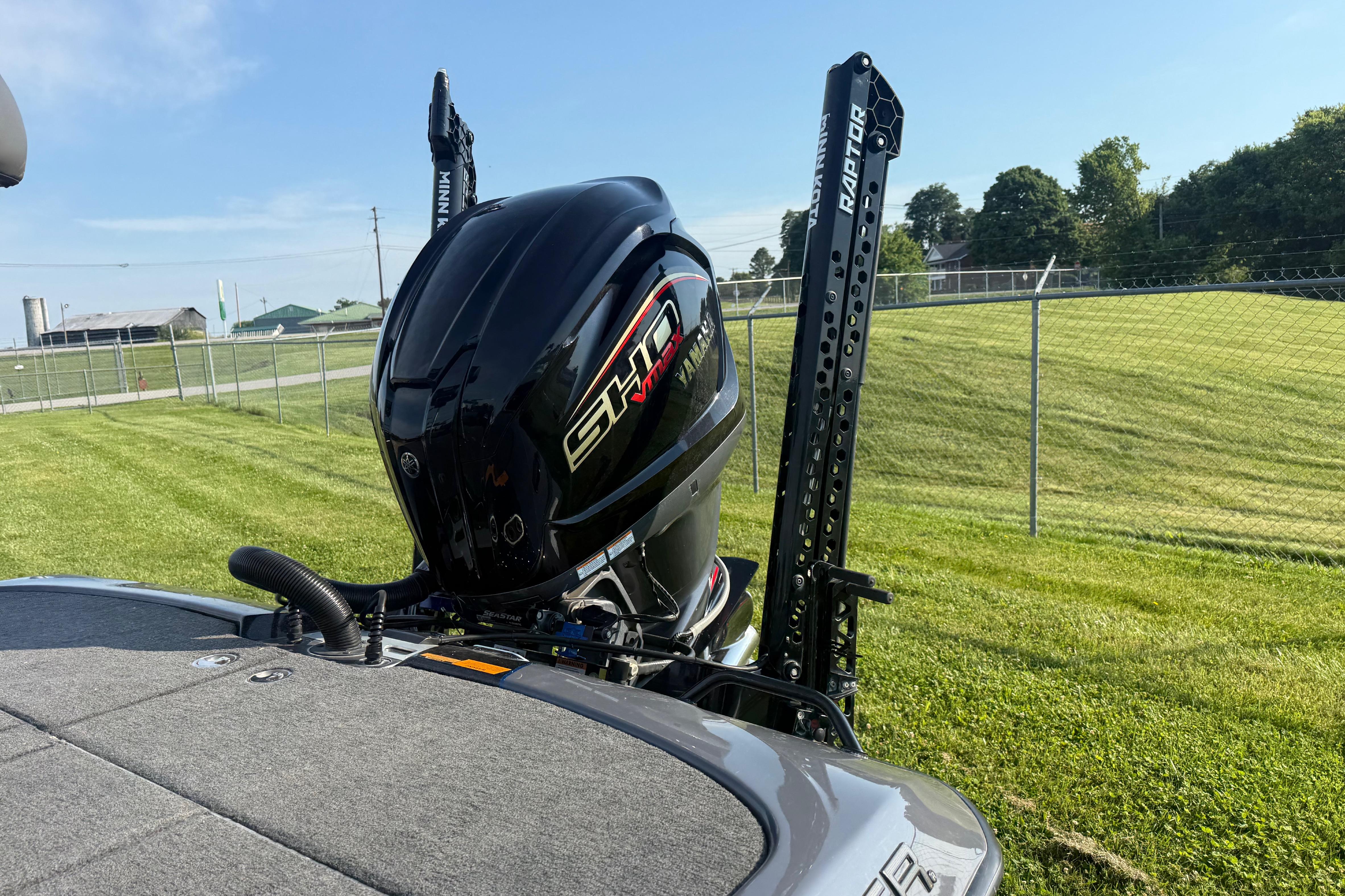 2024 Skeeter FXR21 boat with Yamaha SHO engine and Minn Kota Raptor anchors on grassy field.