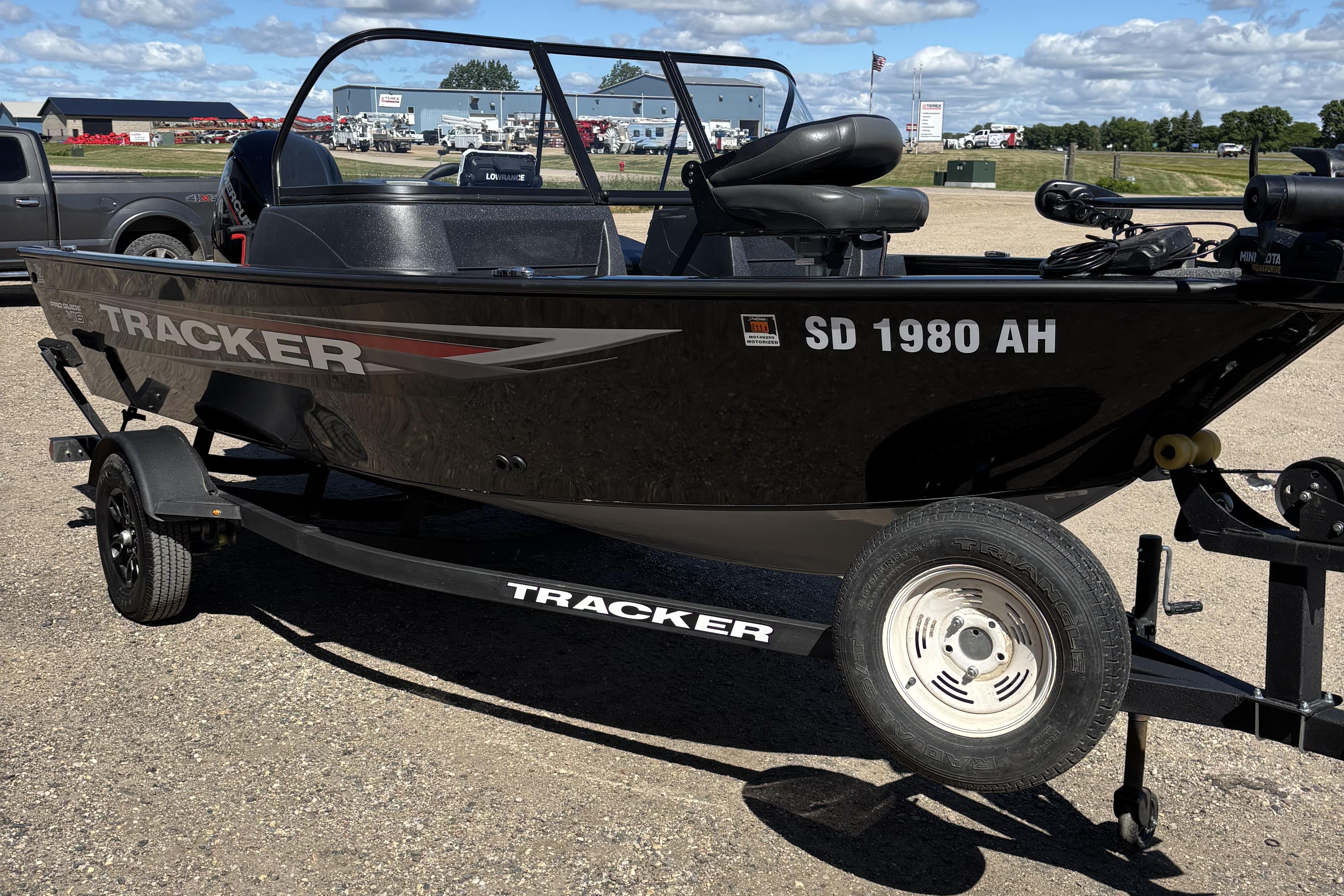 2026 Tracker Pro Guide V-16 WT boat on trailer, parked outdoors.