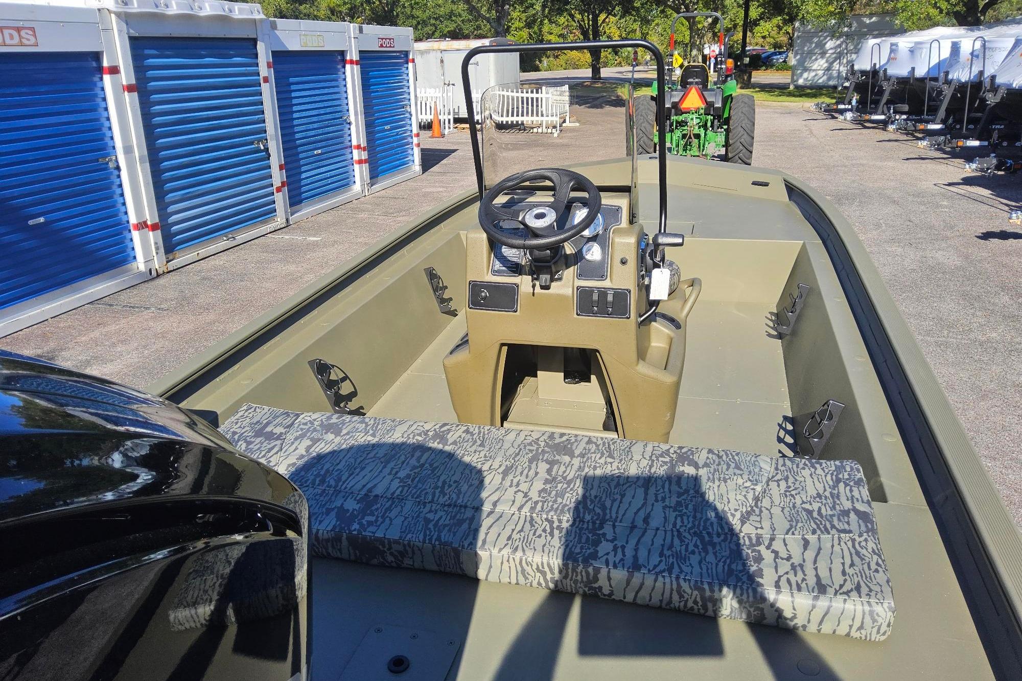 2026 Tracker Grizzly 1860 CC boat interior with steering console and patterned seating.