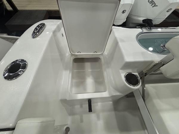 2025 Sea Pro 262 Offshore boat interior with open storage compartment and cup holders.
