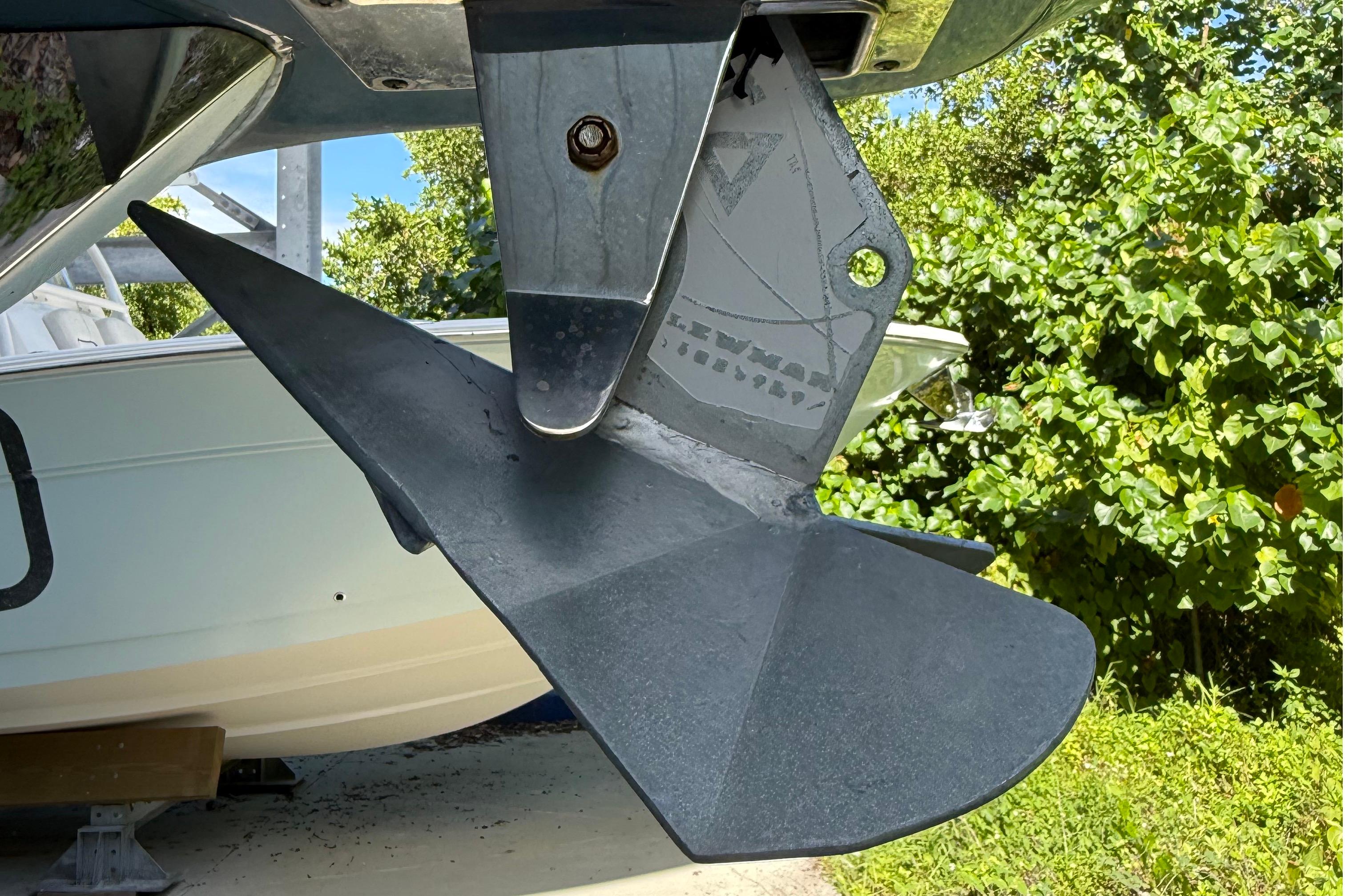 Close-up of a 2008 Century 2901 Center Console boat's anchor against greenery.